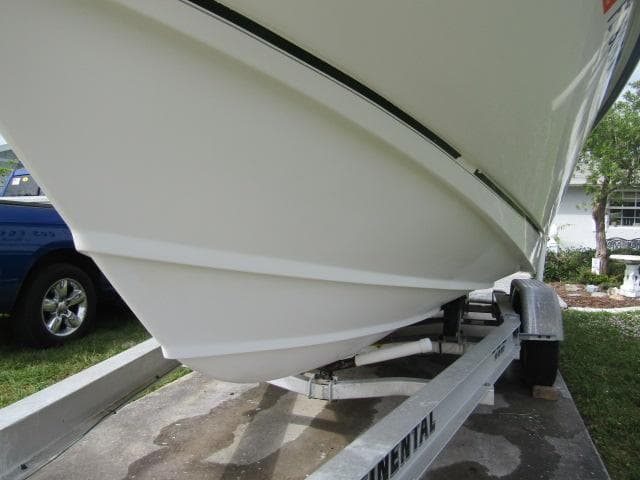 1999 Boston Whaler 23 Outrage boat on trailer, side view.