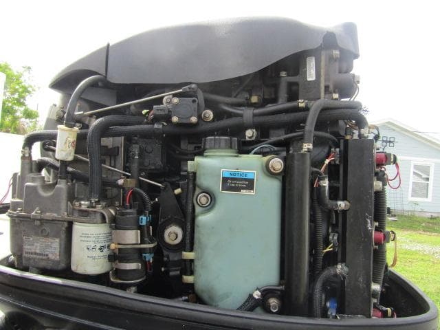 Close-up of a 1999 Boston Whaler 23 Outrage boat engine components.