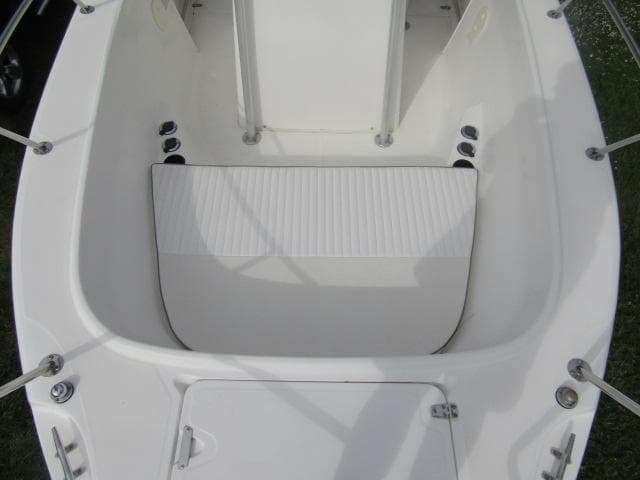 1999 Boston Whaler 23 Outrage boat interior, featuring seating and storage compartments.