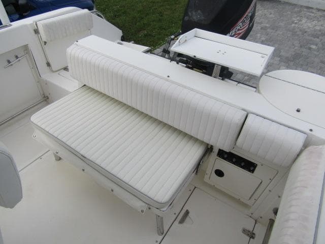 1999 Boston Whaler 23 Outrage boat interior with white cushioned seating.