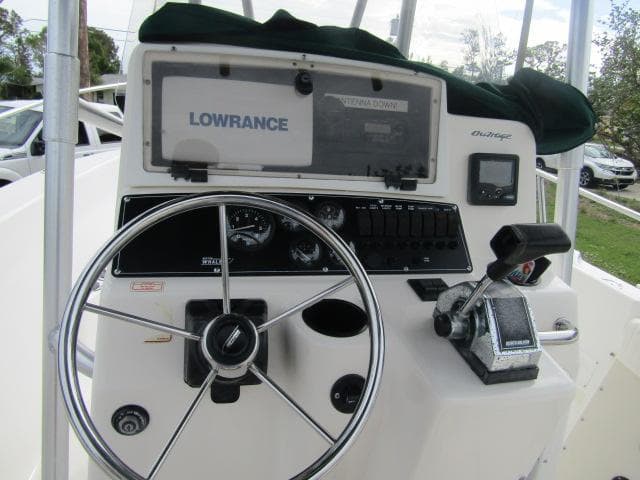 1999 Boston Whaler 23 Outrage boat dashboard with steering wheel and Lowrance navigation system.