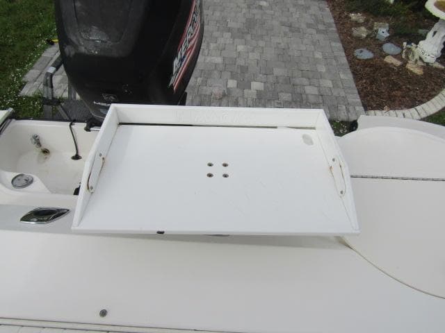 1999 Boston Whaler 23 Outrage boat with white deck and motor.