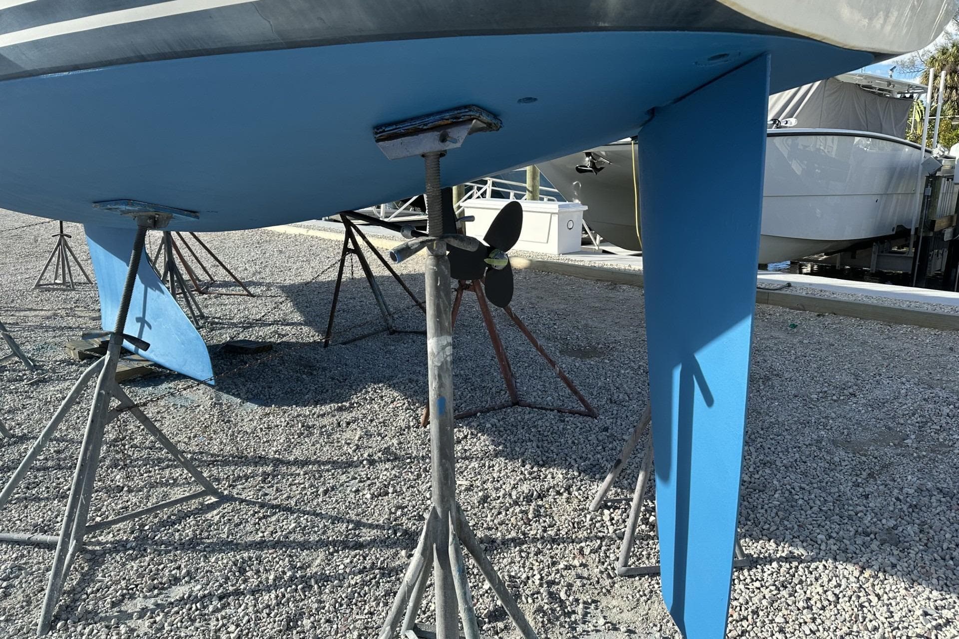 2004 J Boats J/32 sailboat hull and propeller on stands in a boatyard.