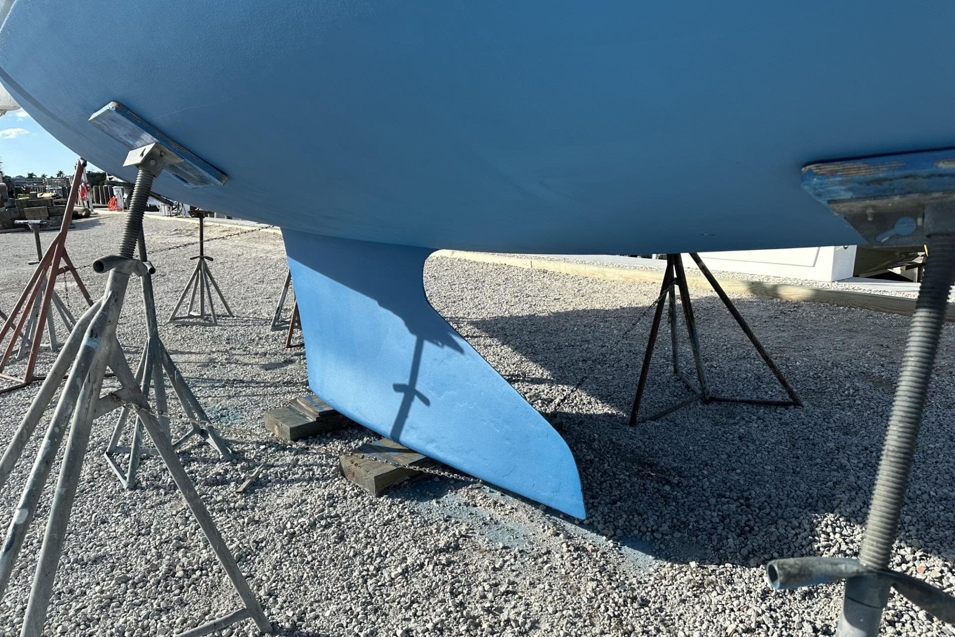 2004 J Boats J/32 sailboat keel on stands in a boatyard.