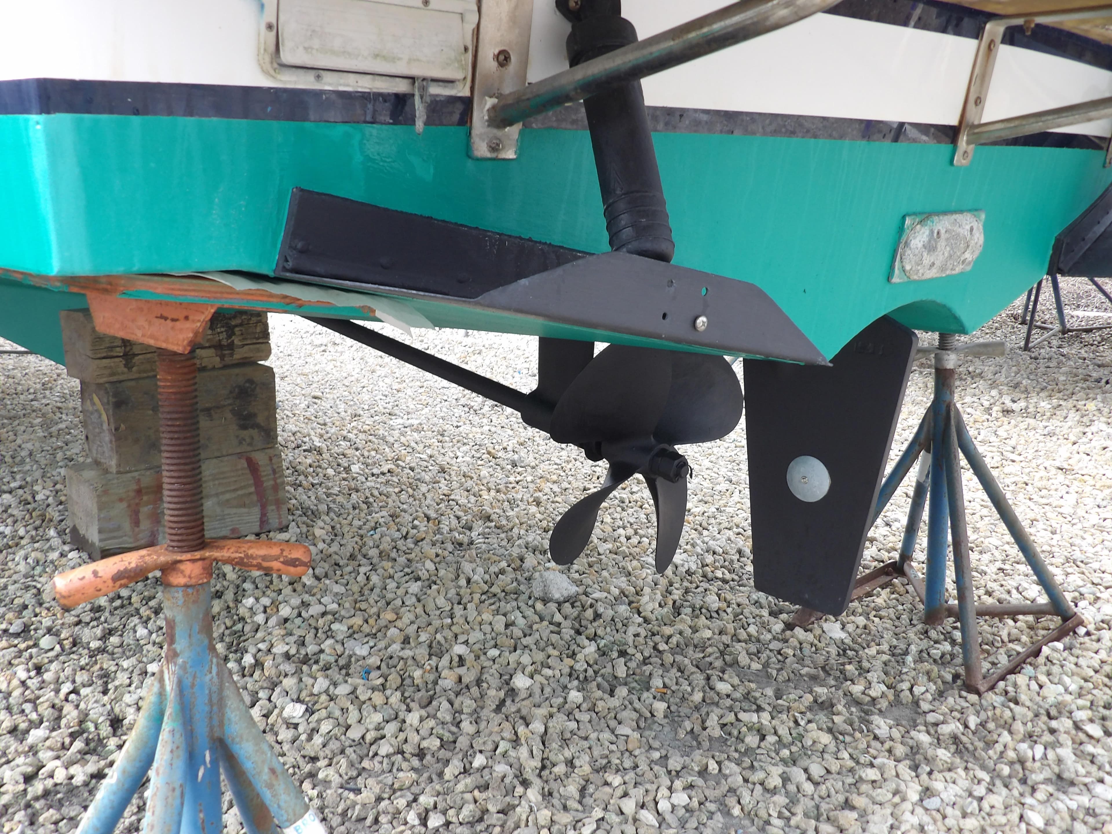 2002 Legacy Yachts 28 Express boat propeller and hull on stands.