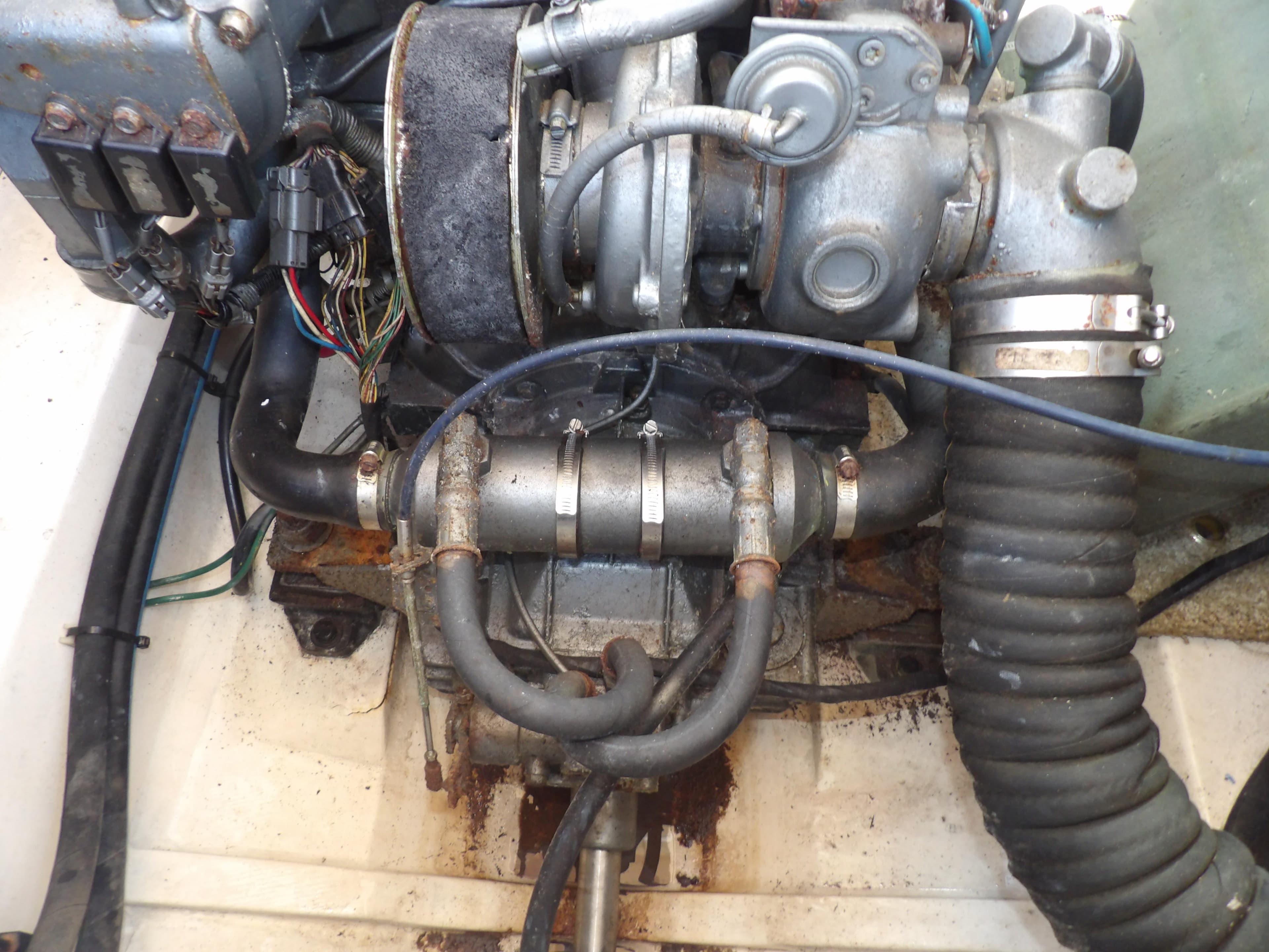 Engine compartment of a 2002 Legacy Yachts 28 Express, showing mechanical components and wiring.