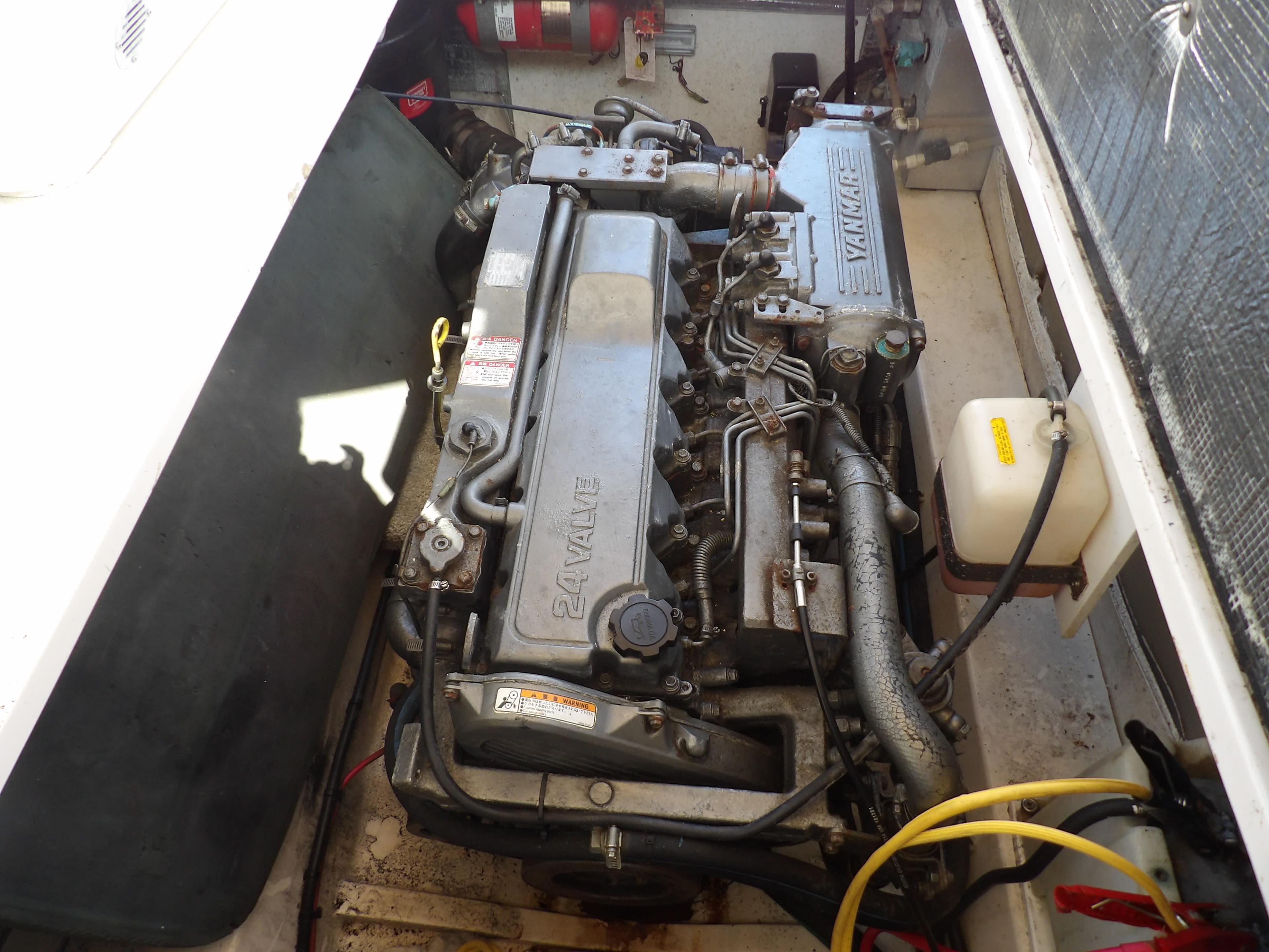 Engine compartment of a 2002 Legacy Yachts 28 Express, featuring a Yanmar engine.