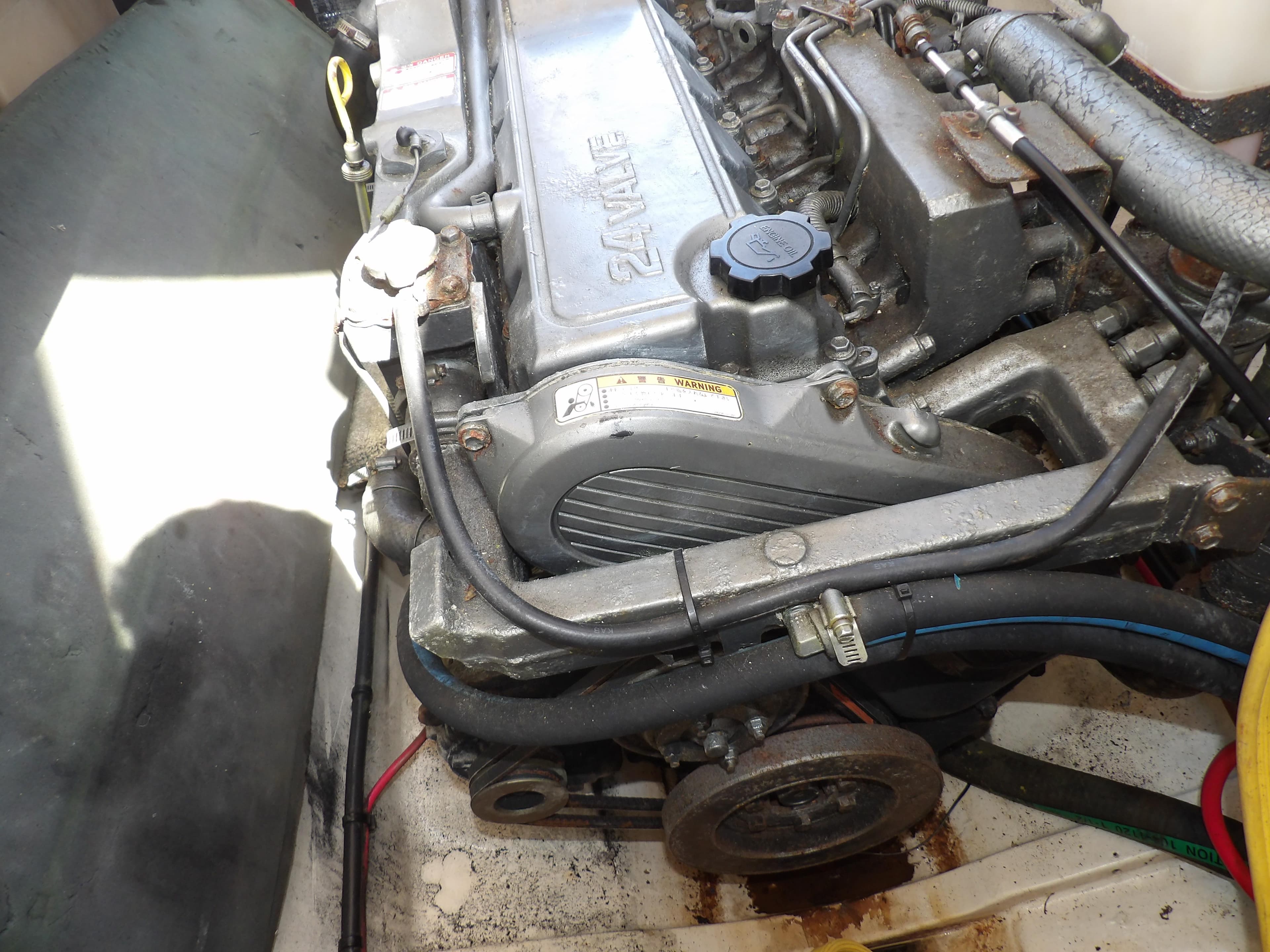 Engine compartment of a 2002 Legacy Yachts 28 Express, showcasing mechanical components.