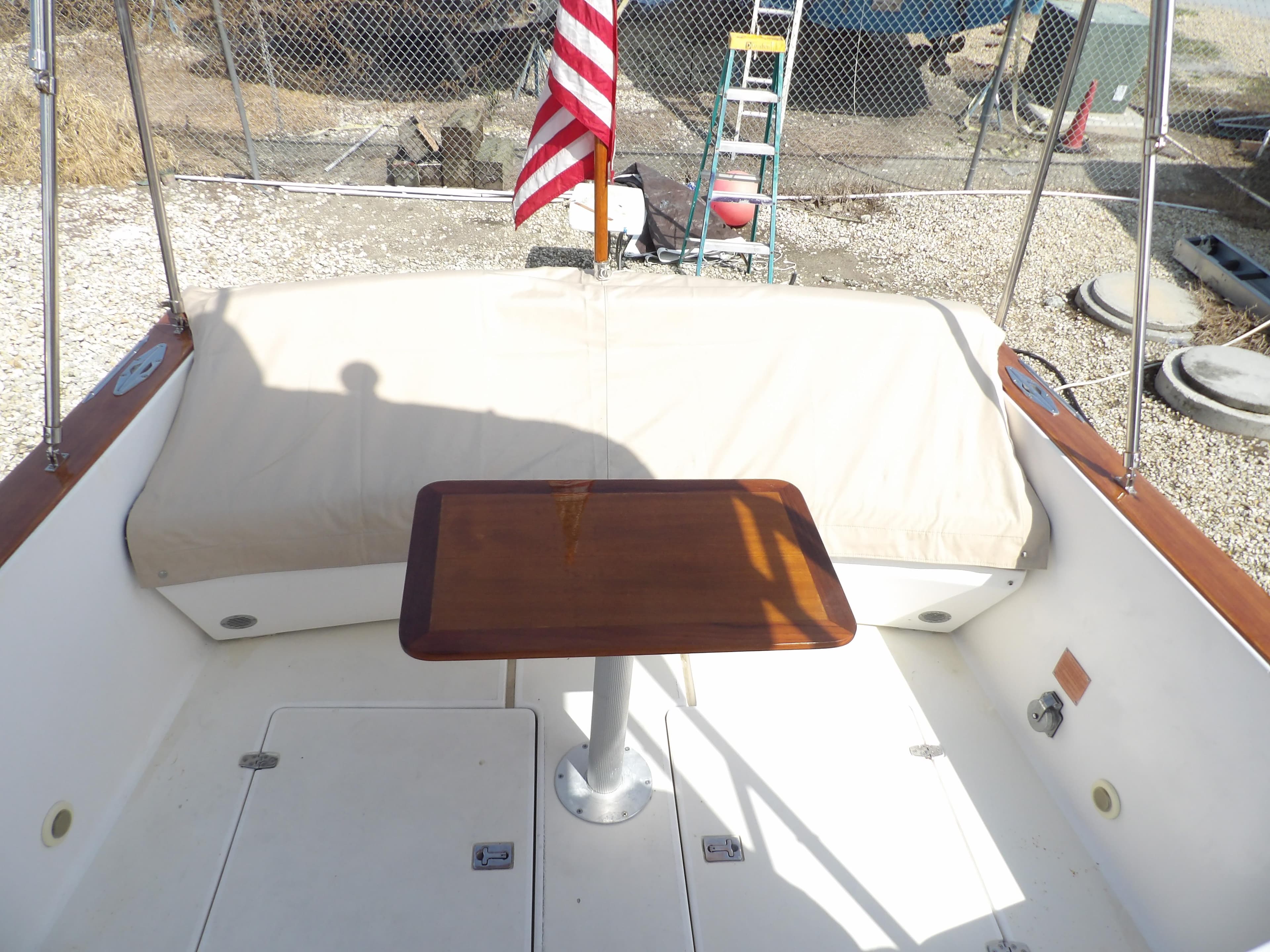 2002 Legacy Yachts 28 Express cockpit with table and American flag.