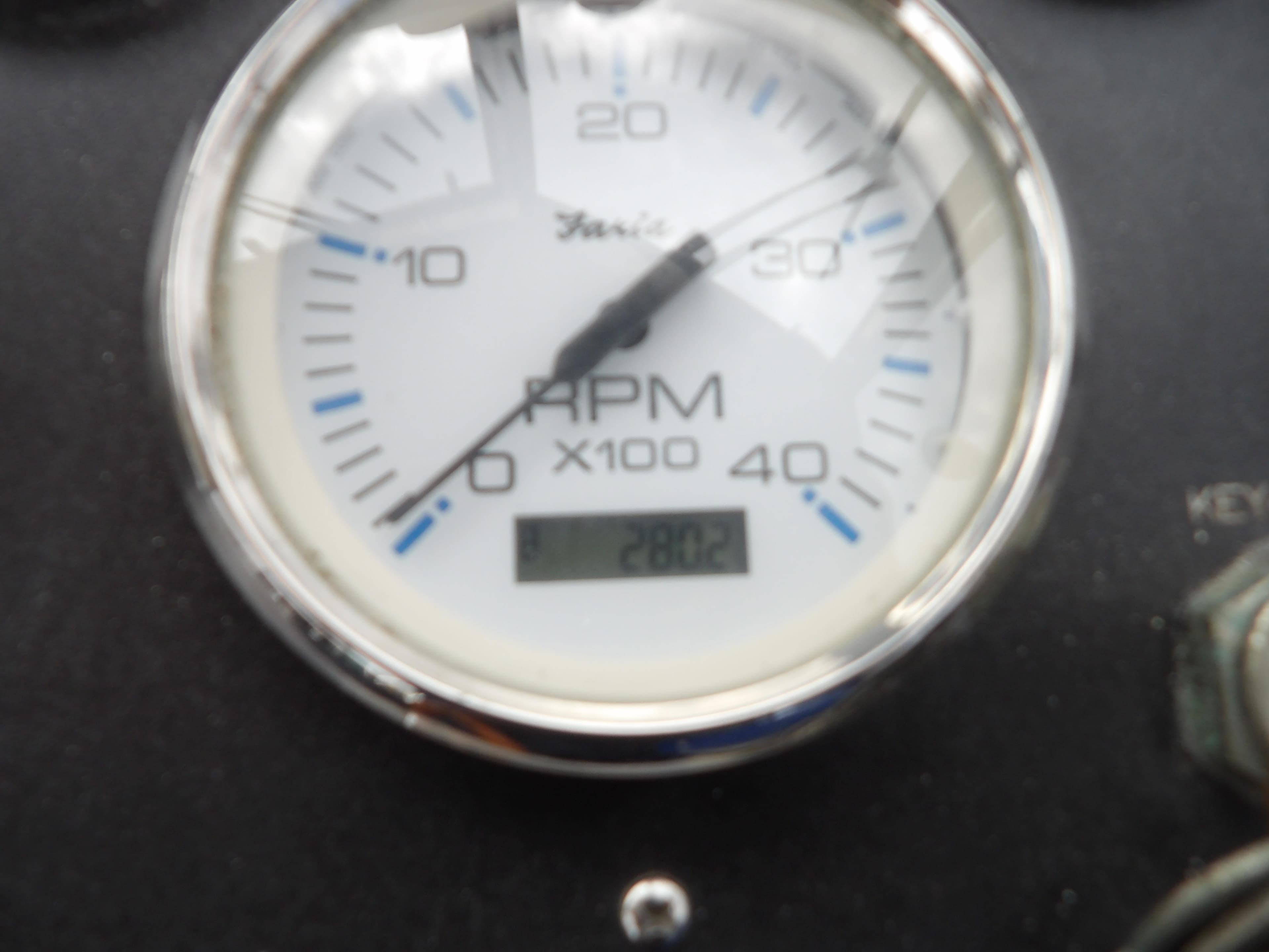 RPM gauge on 2002 Legacy Yachts 28 Express dashboard, showing 2802 hours.