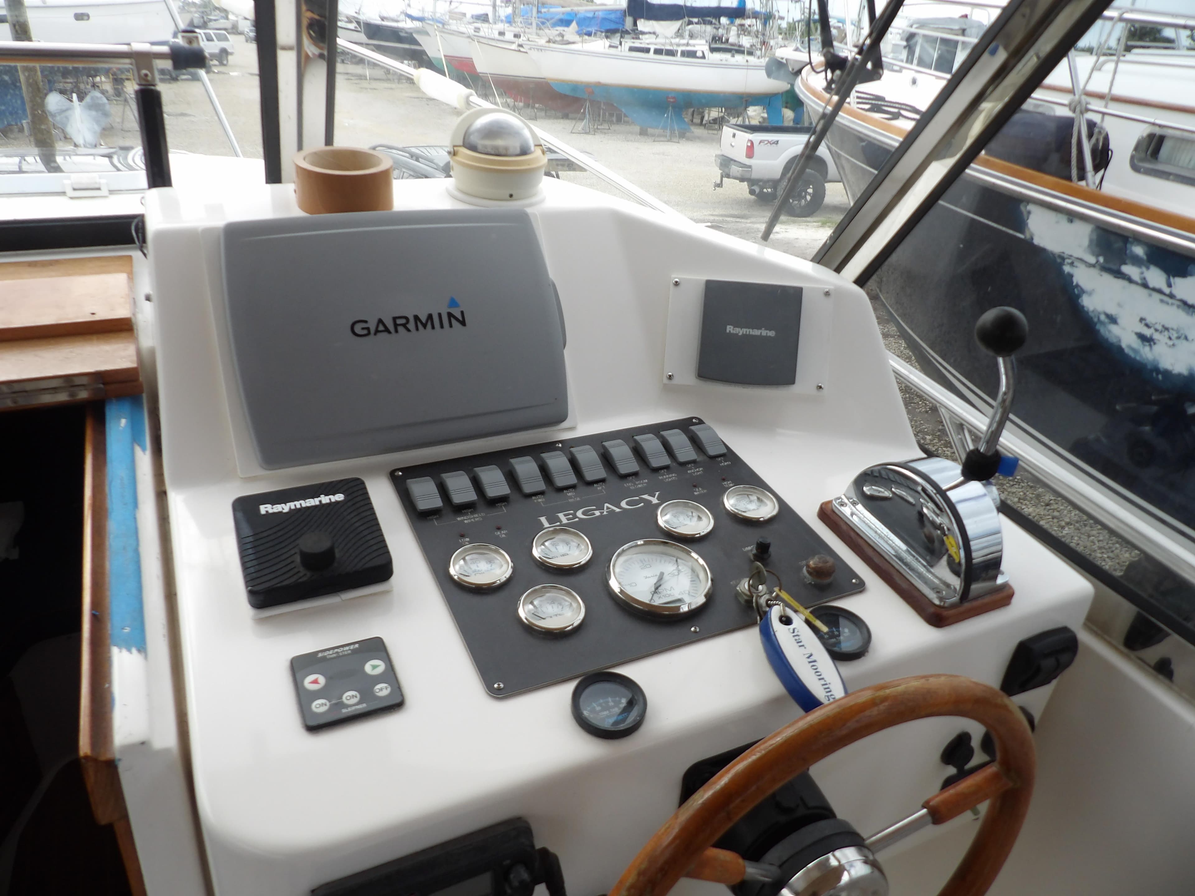 Helm of 2002 Legacy Yachts 28 Express with Garmin navigation and control instruments.