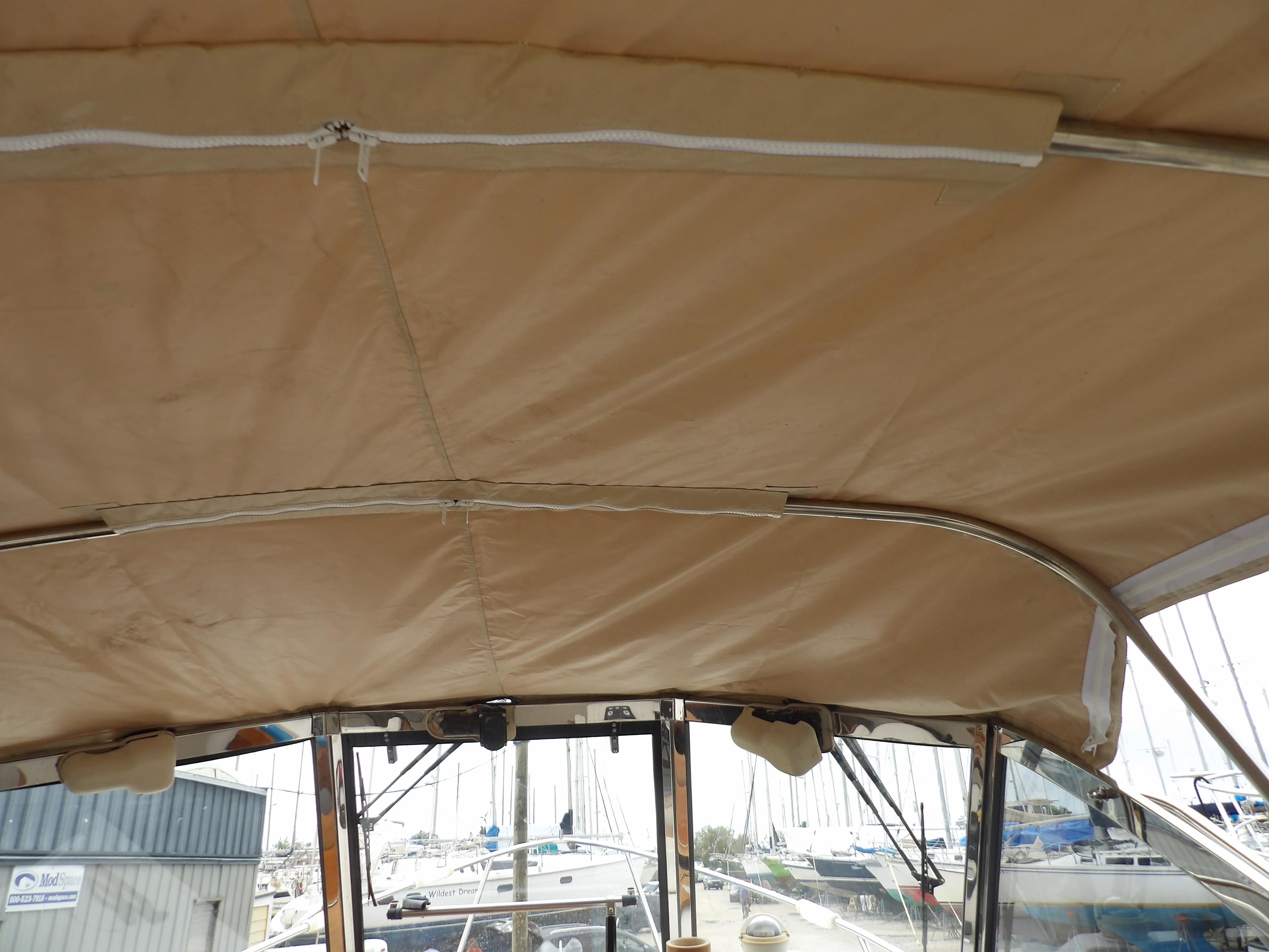 2002 Legacy Yachts 28 Express boat canopy with marina background.