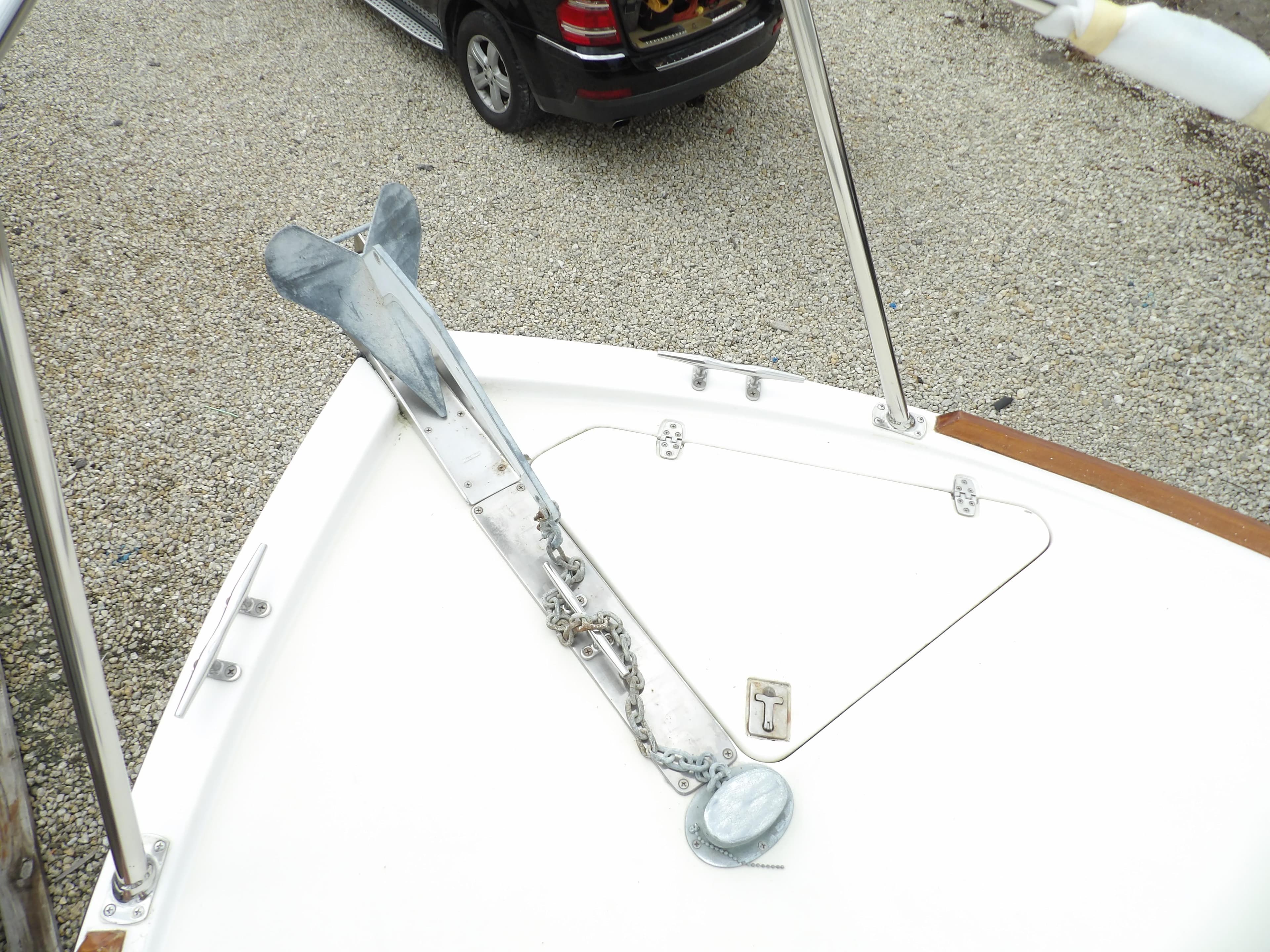 Bow of 2002 Legacy Yachts 28 Express with anchor and chain on deck.