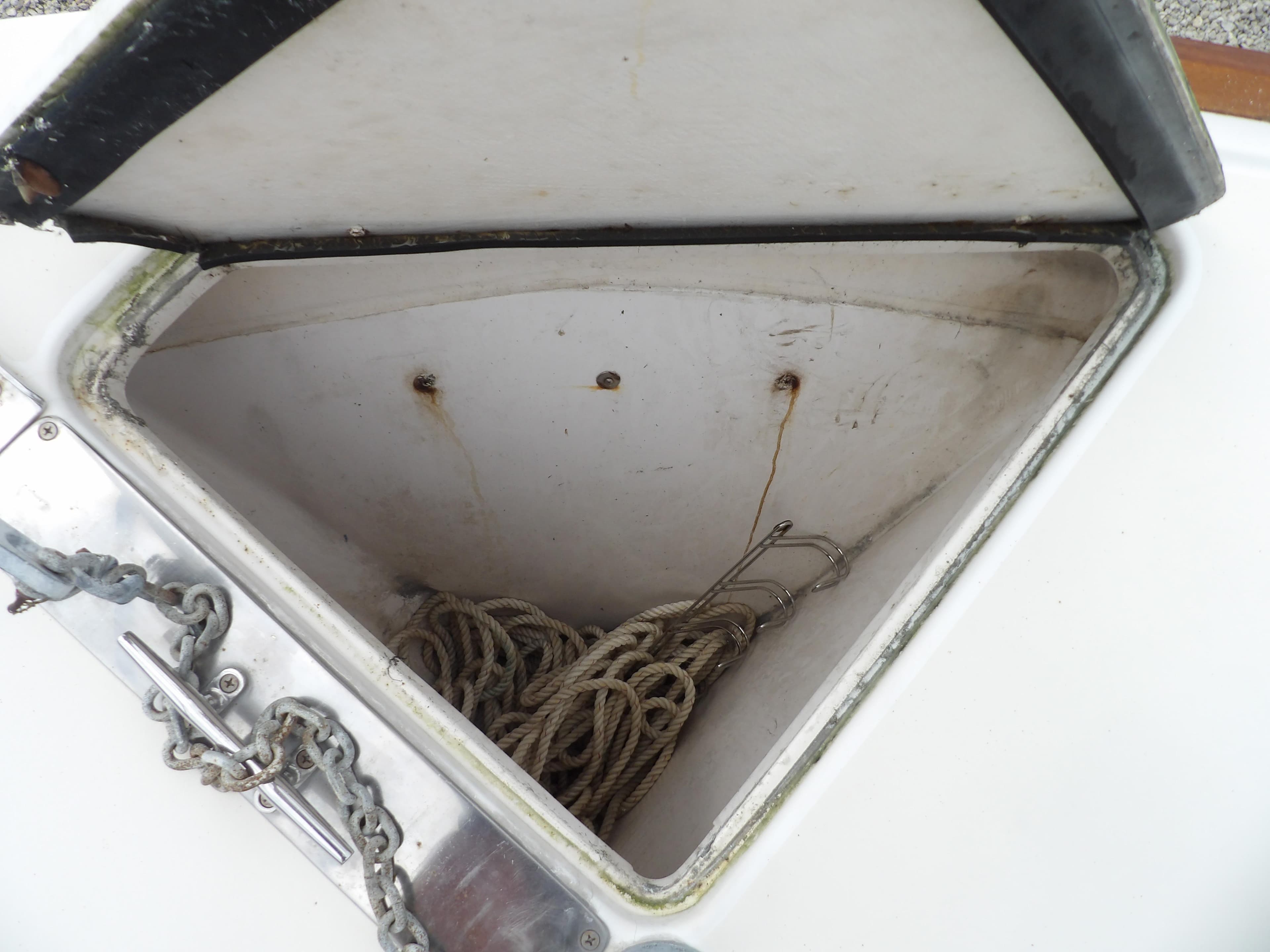 Open anchor locker on 2002 Legacy Yachts 28 Express, showing rope and chain storage.