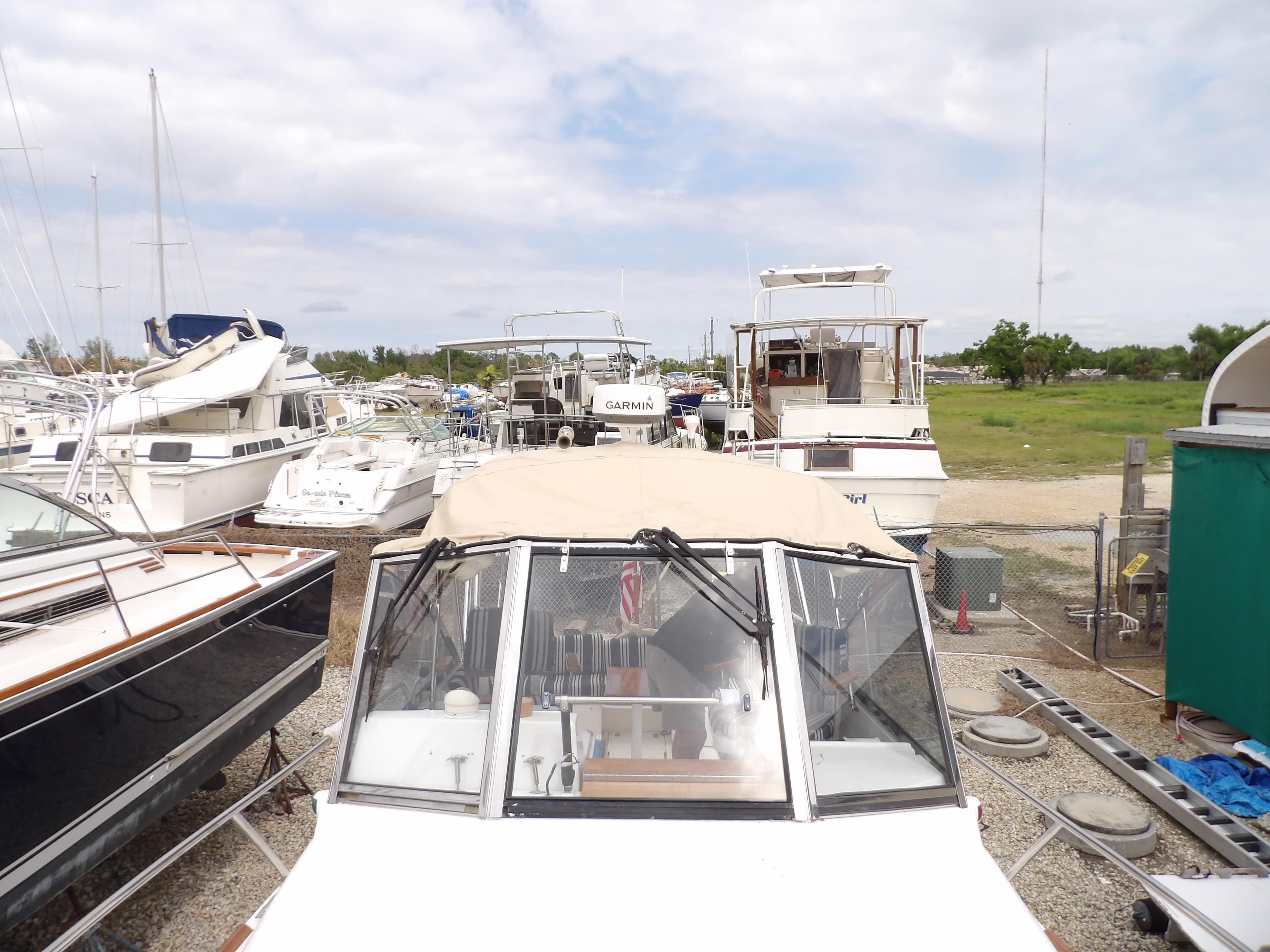 2002 Legacy Yachts 28 Express docked among other boats in a marina.