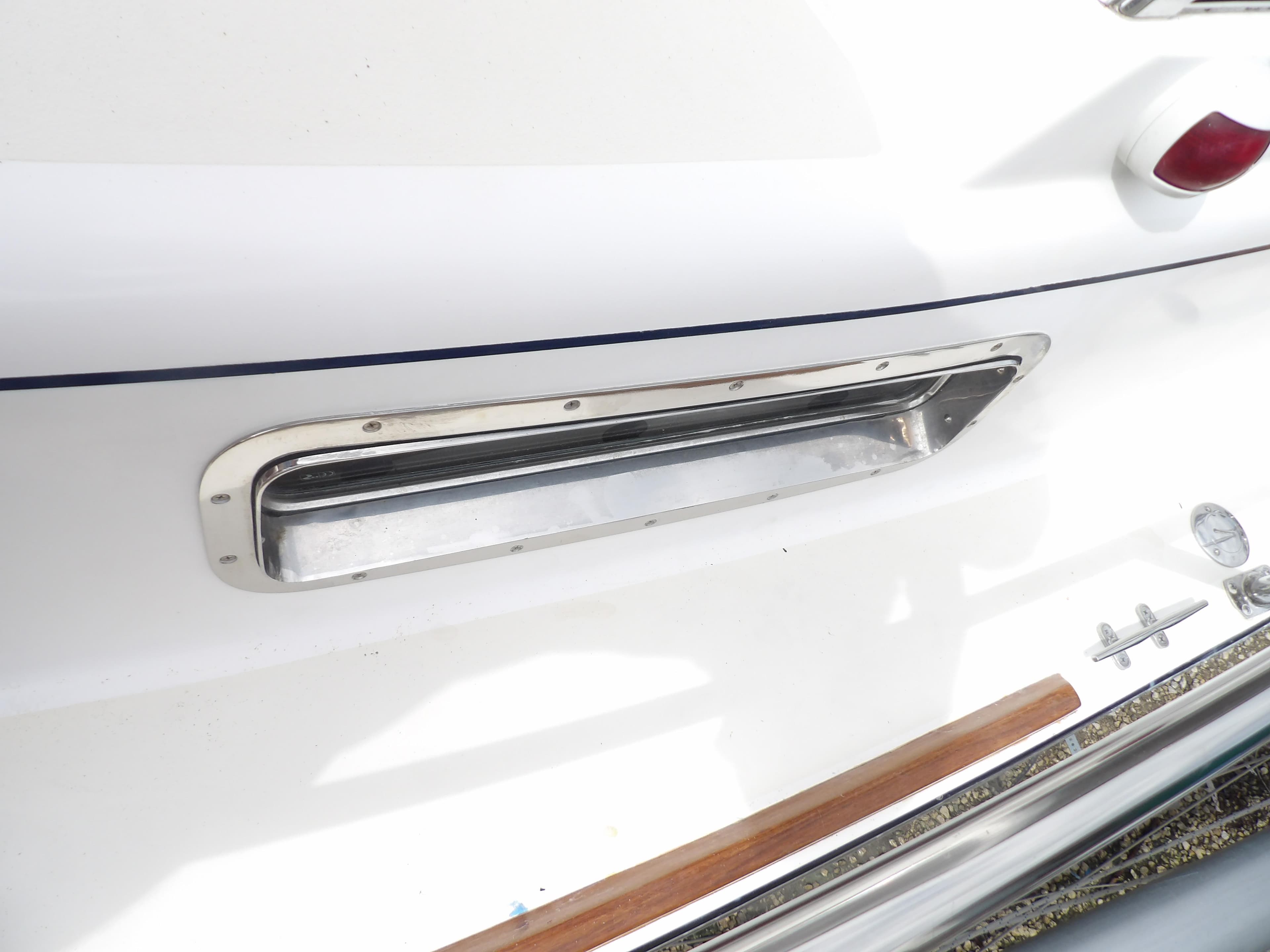 2002 Legacy Yachts 28 Express, close-up of hull detail and chrome trim.