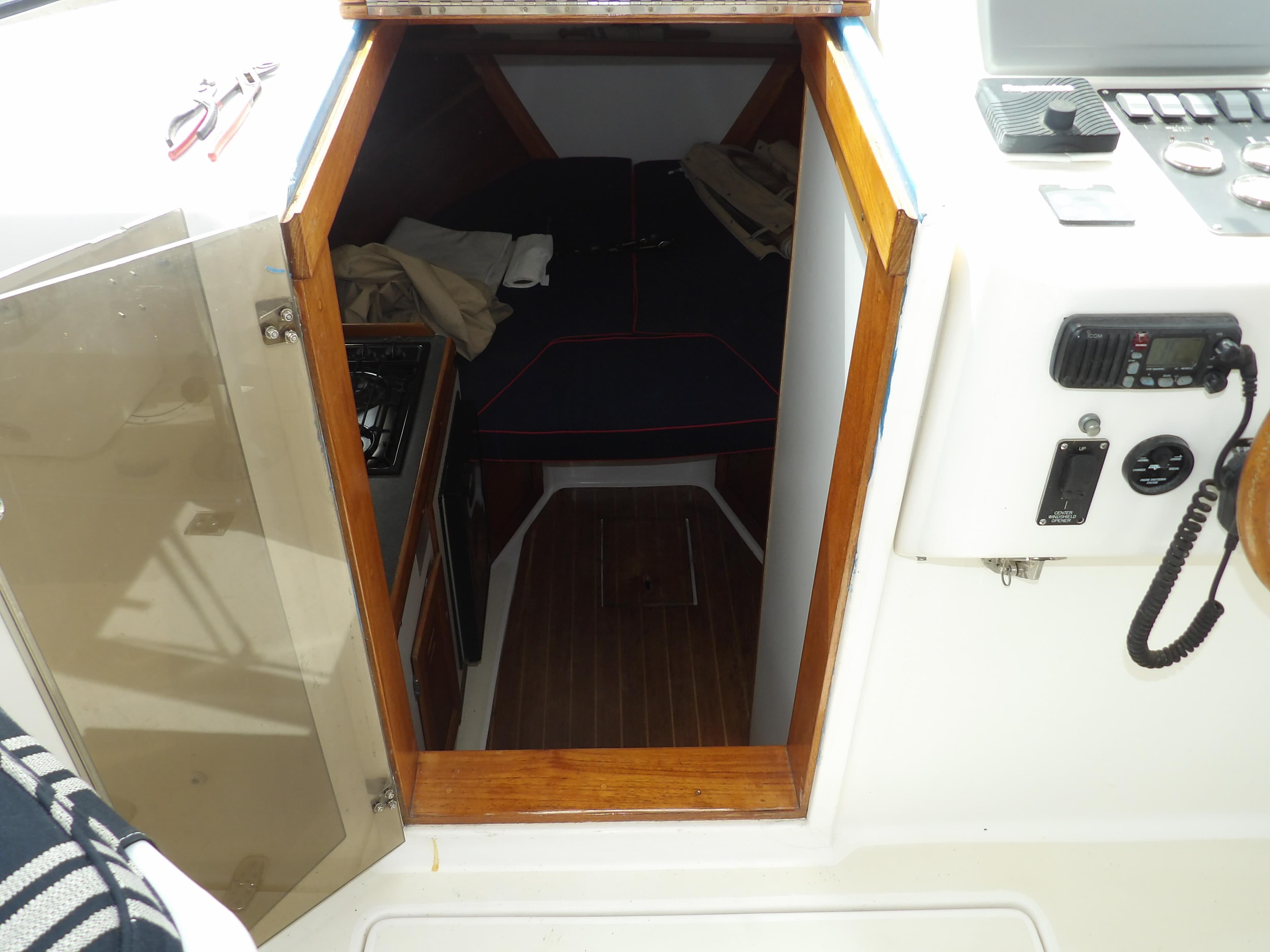2002 Legacy Yachts 28 Express cabin interior with wood trim and nautical equipment.