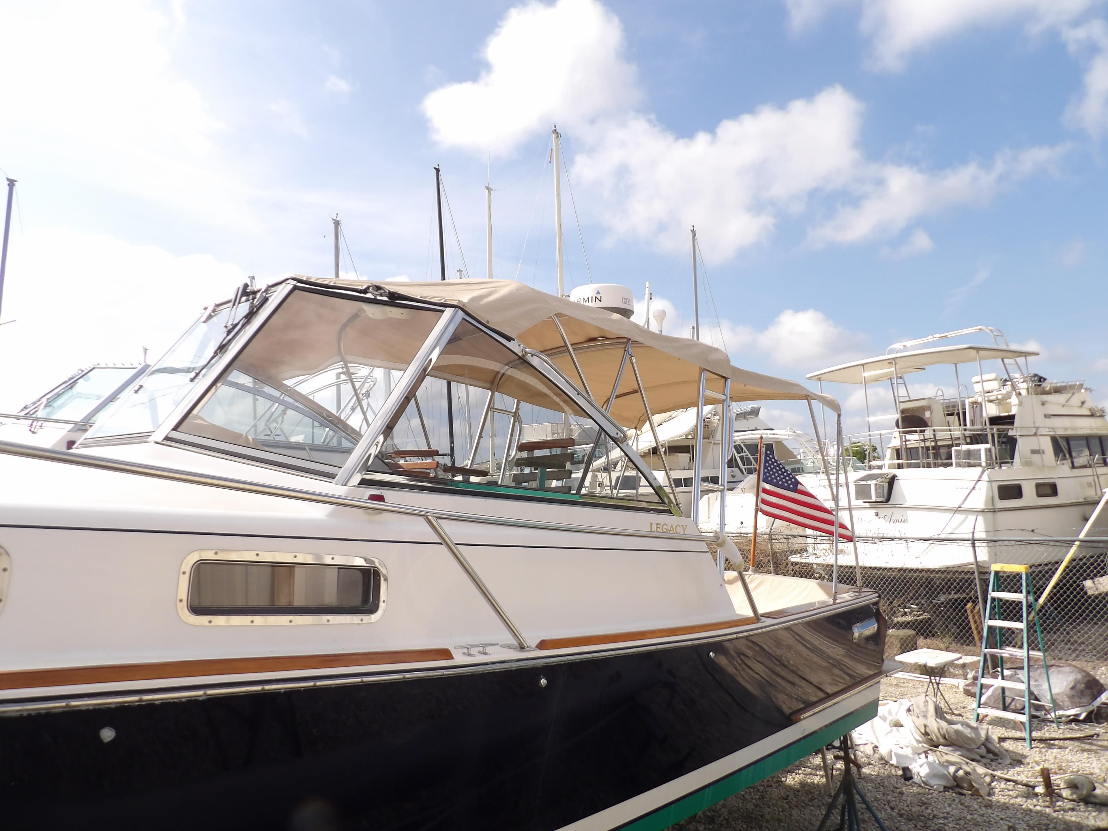 2002 Legacy Yachts 28 Express boat docked under a clear blue sky.