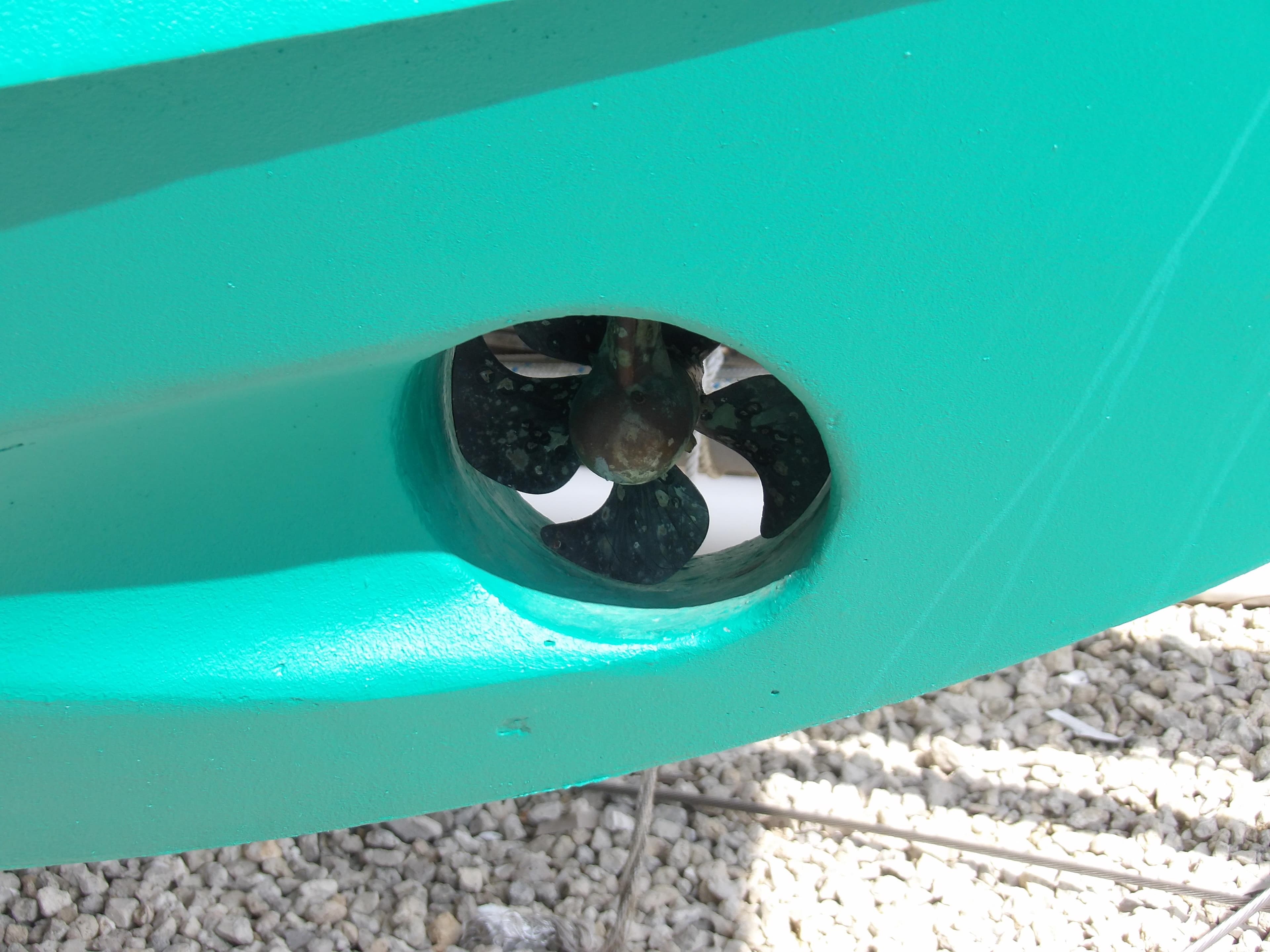 Close-up of a 2002 Legacy Yachts 28 Express propeller in turquoise hull.