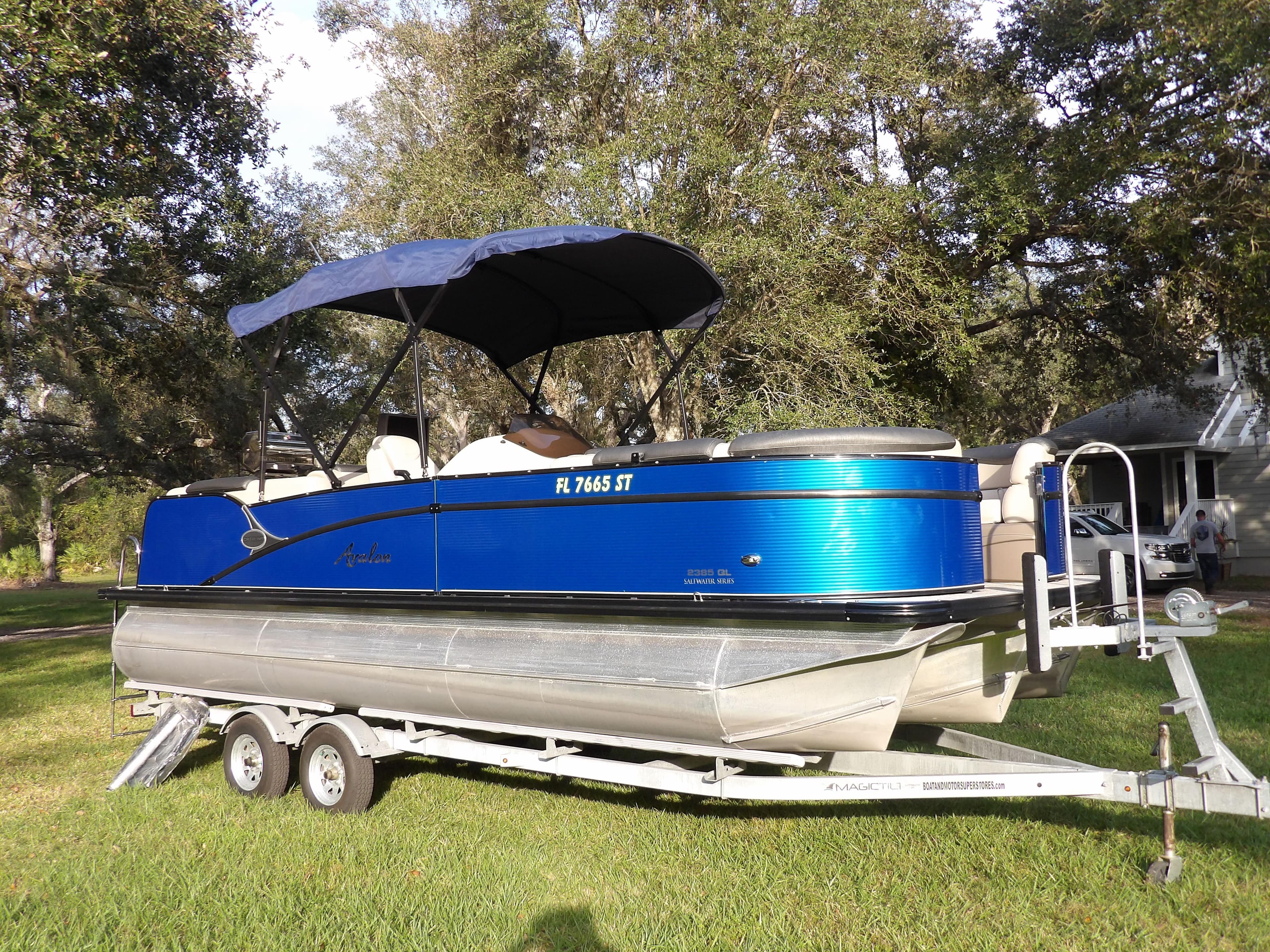 2020 Avalon 2385 Catalina QL SWS pontoon boat on trailer with blue canopy.