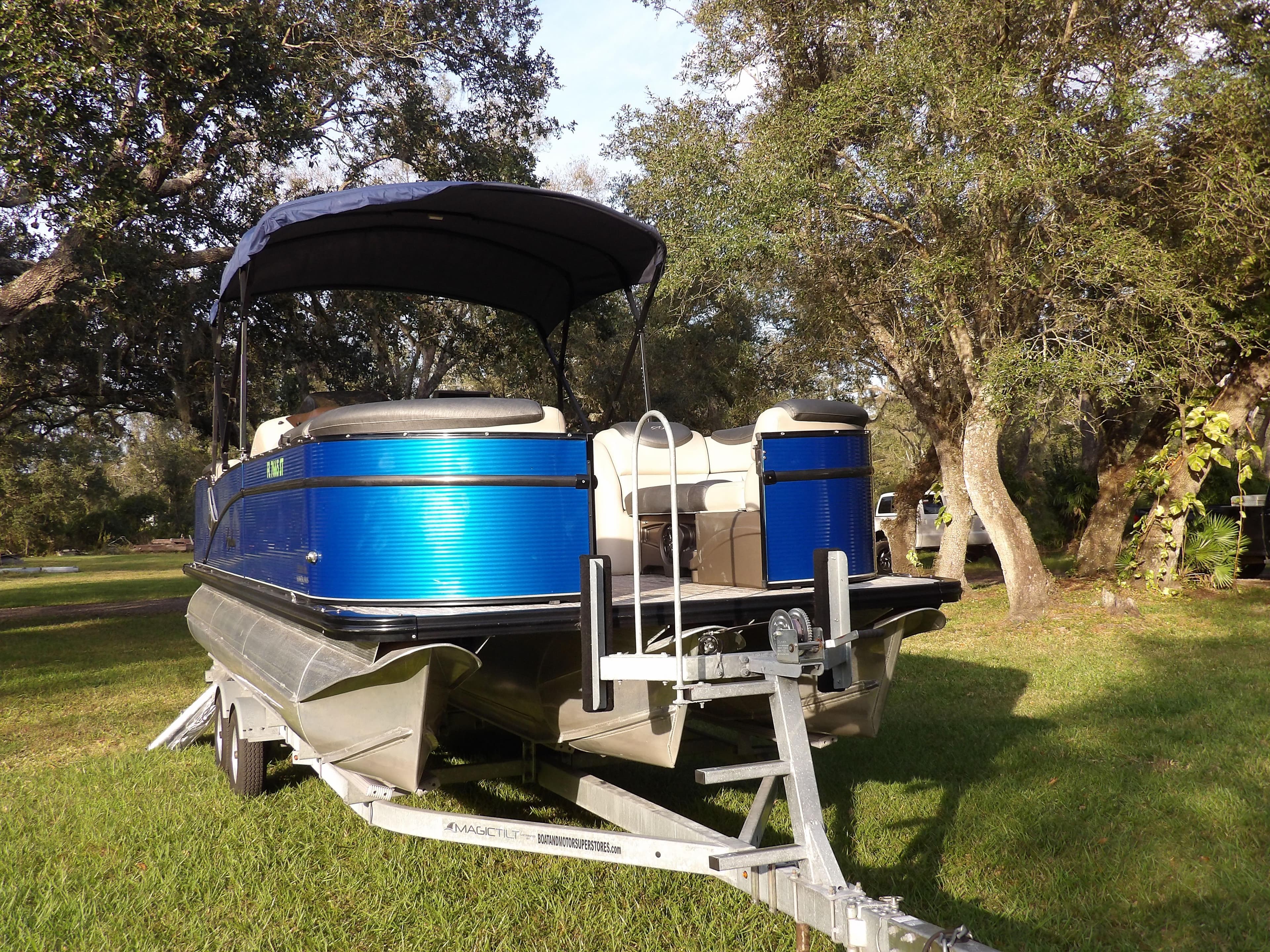 2020 Avalon 2385 Catalina QL SWS pontoon boat on trailer in grassy area.