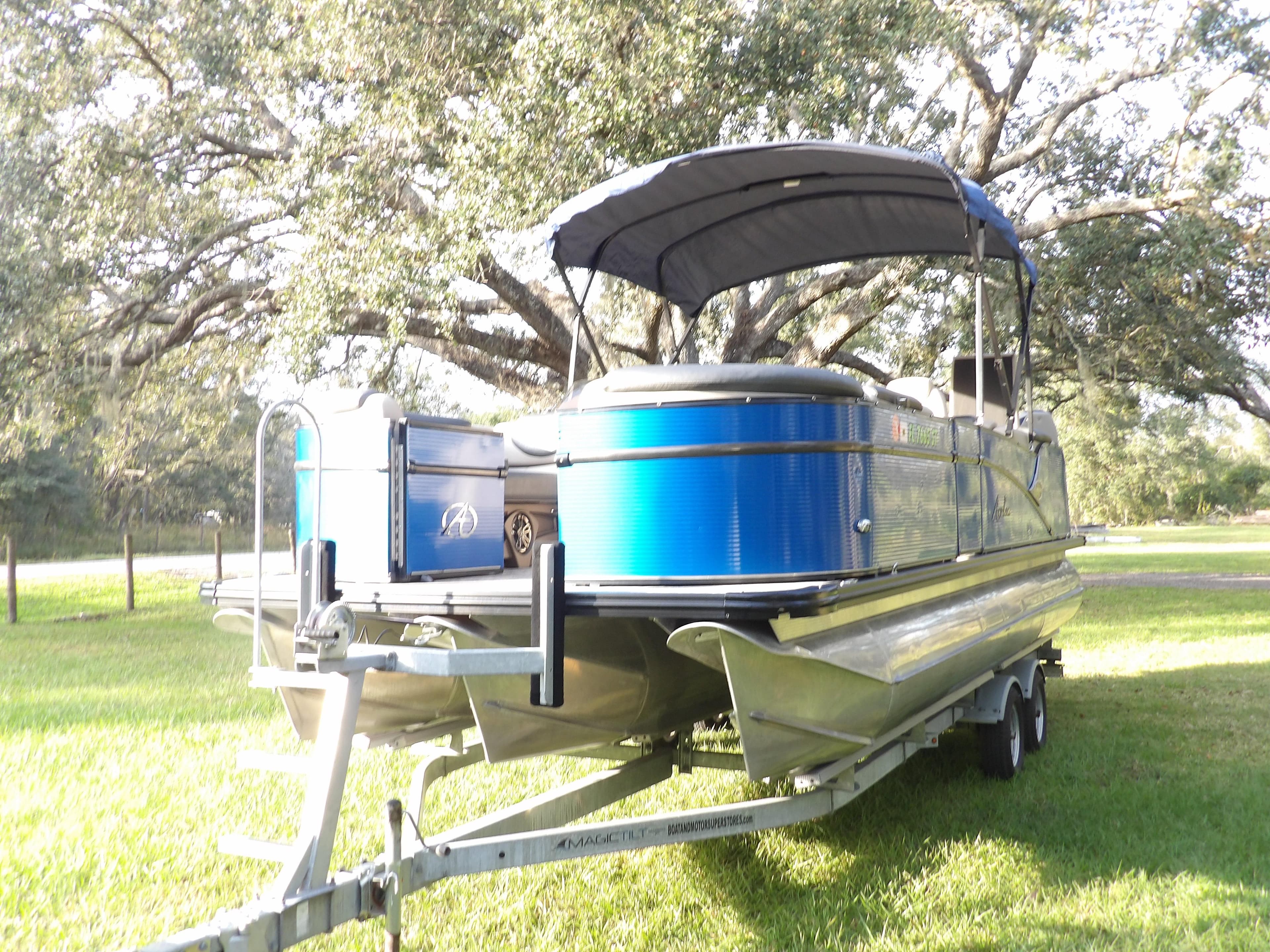2020 Avalon 2385 Catalina QL SWS pontoon boat on a trailer in a grassy area.