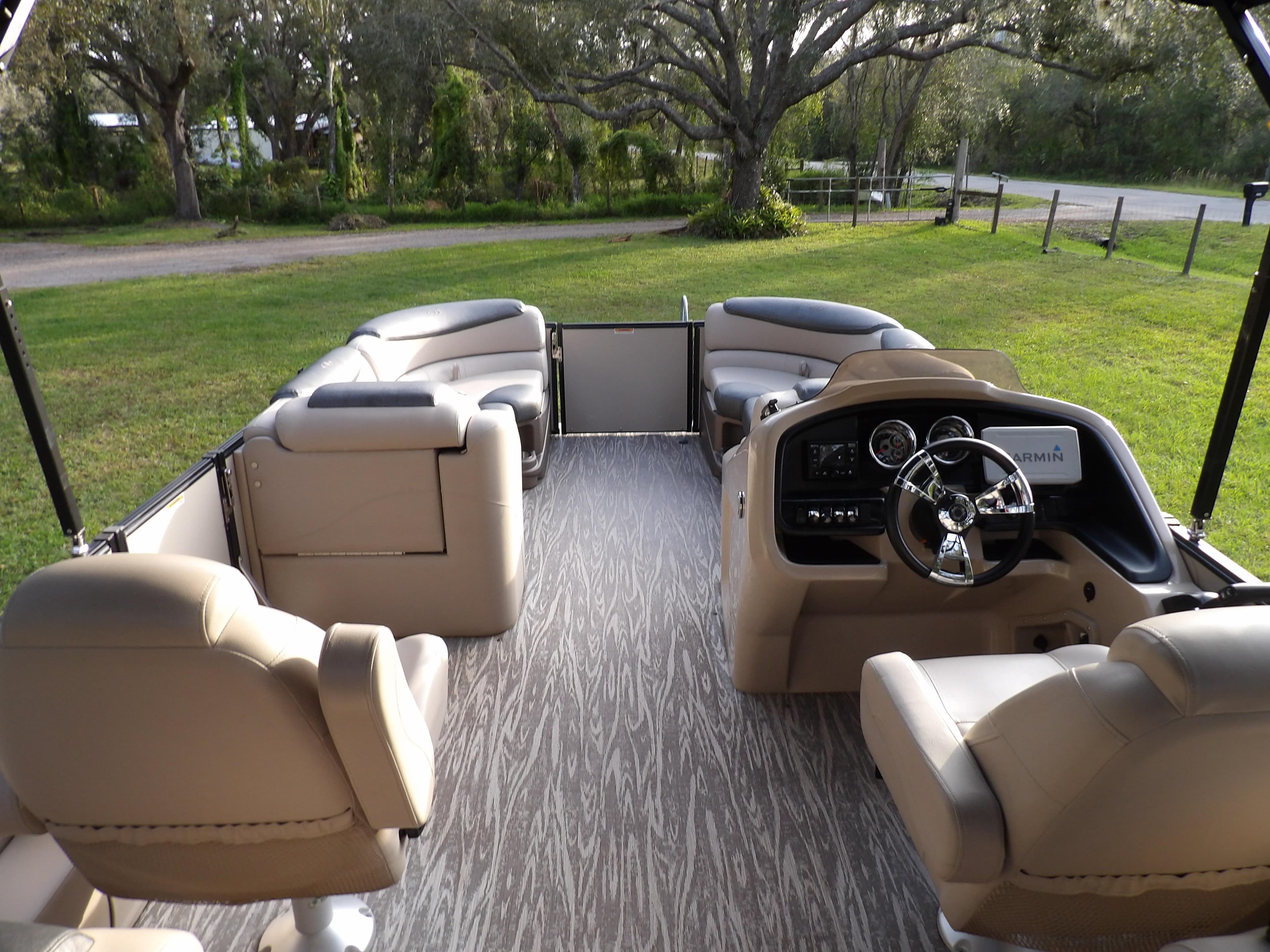 2020 Avalon 2385 Catalina QL SWS pontoon boat interior with beige seating and steering console.