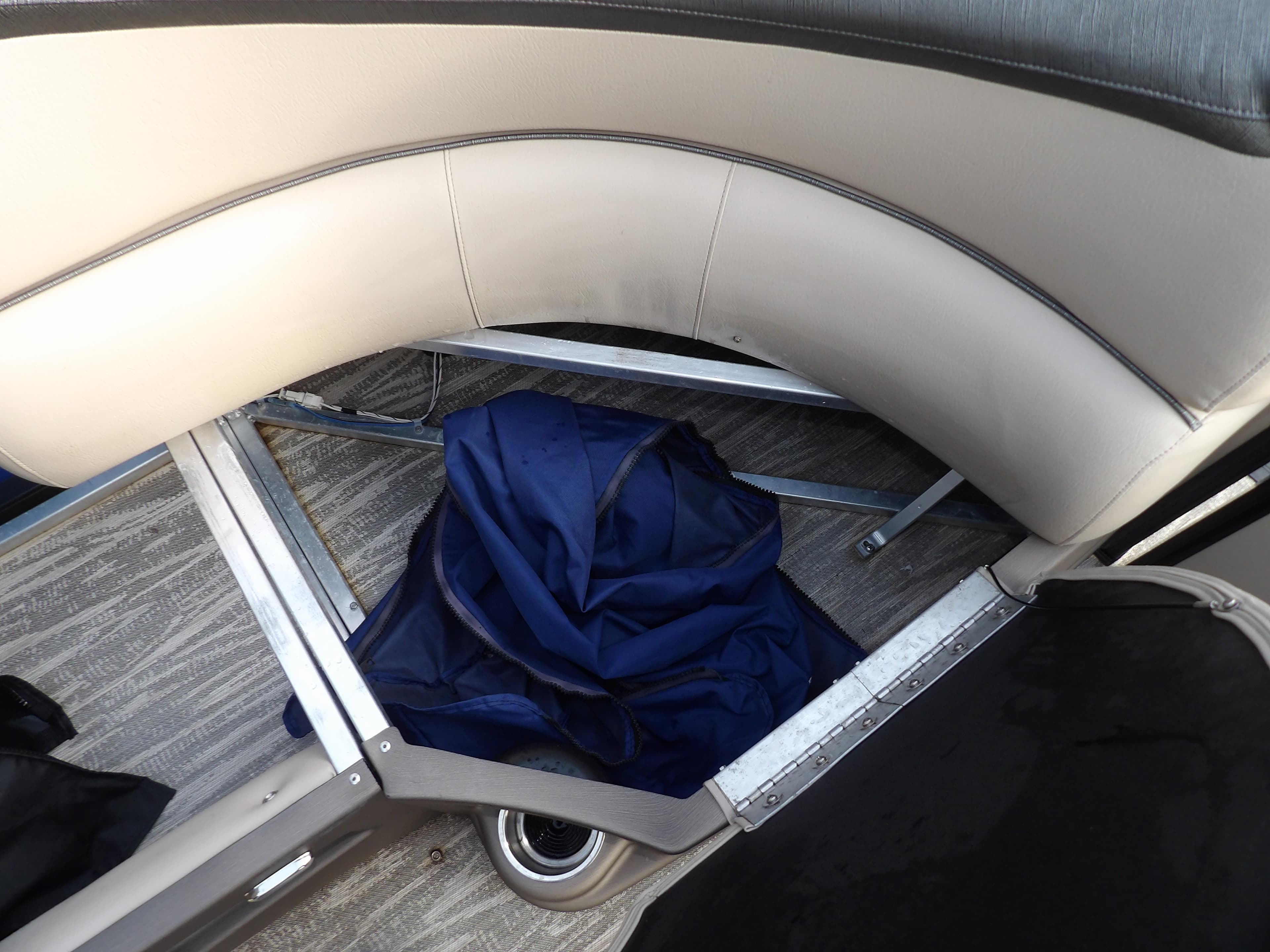 2020 Avalon 2385 Catalina QL SWS boat interior storage compartment with blue cover.