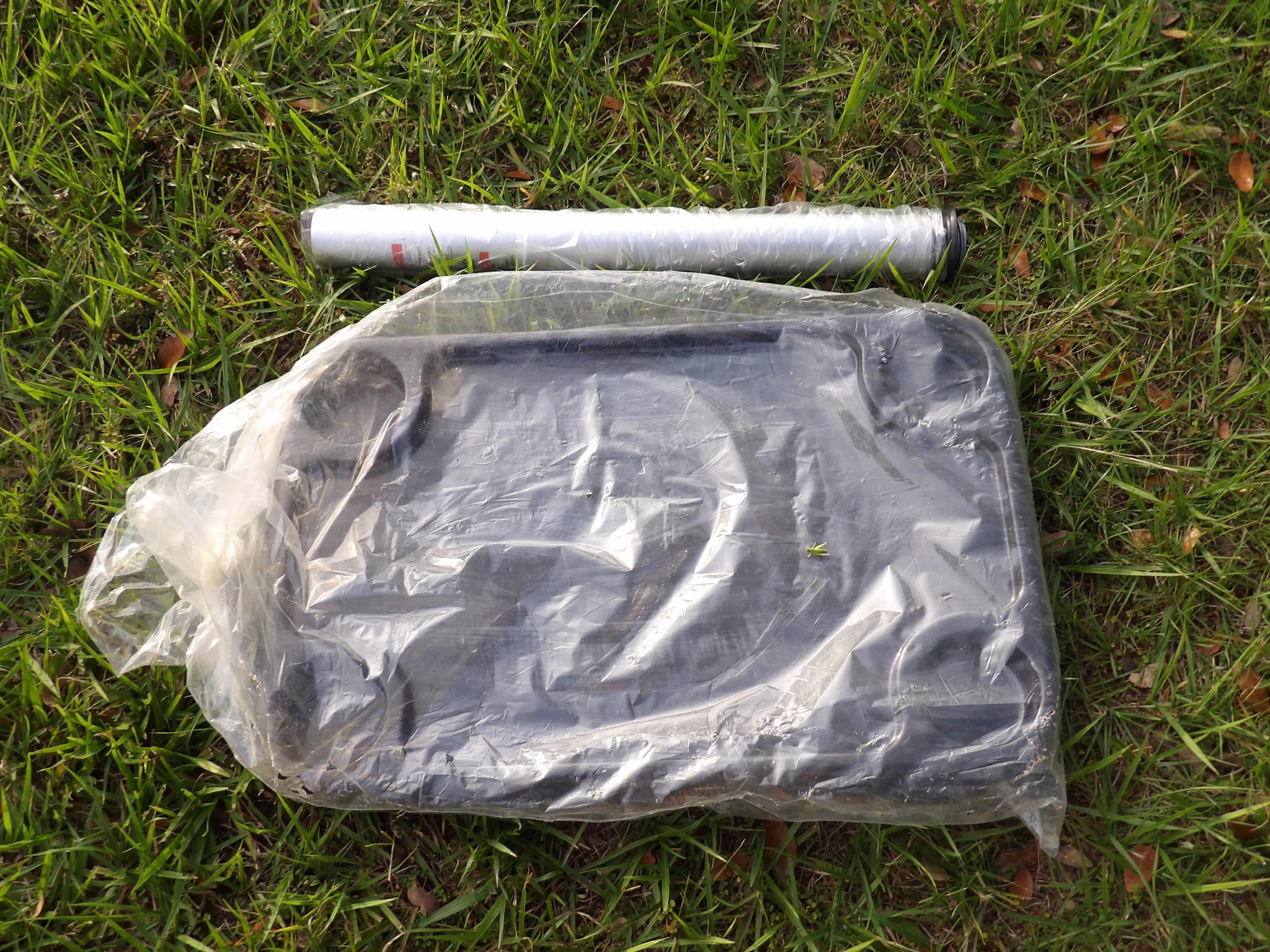 Plastic-wrapped parts for 2020 Avalon 2385 Catalina QL SWS on grass.