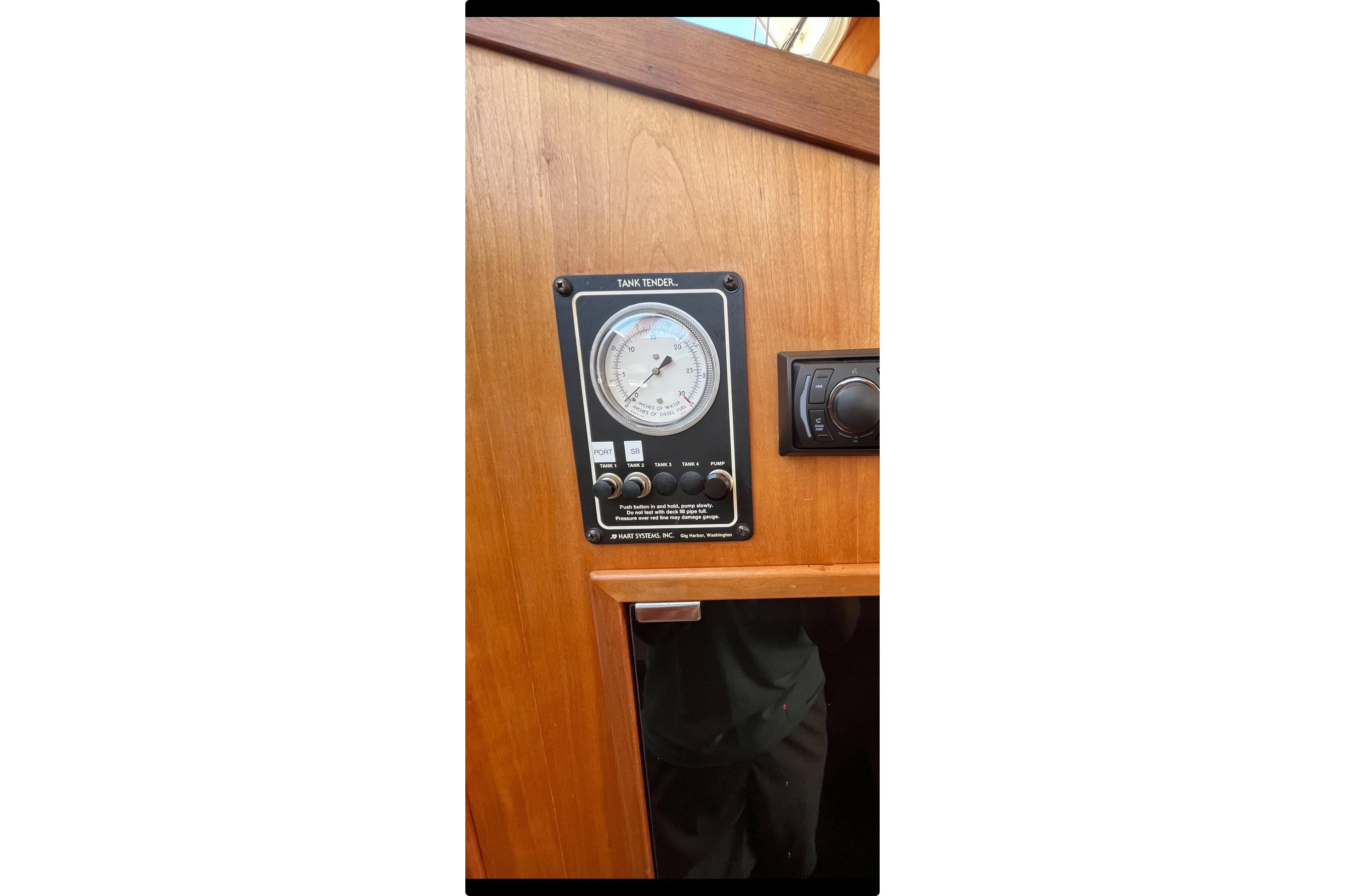 Tank tender gauge on 1999 Sabre 34 boat, mounted on wooden panel.