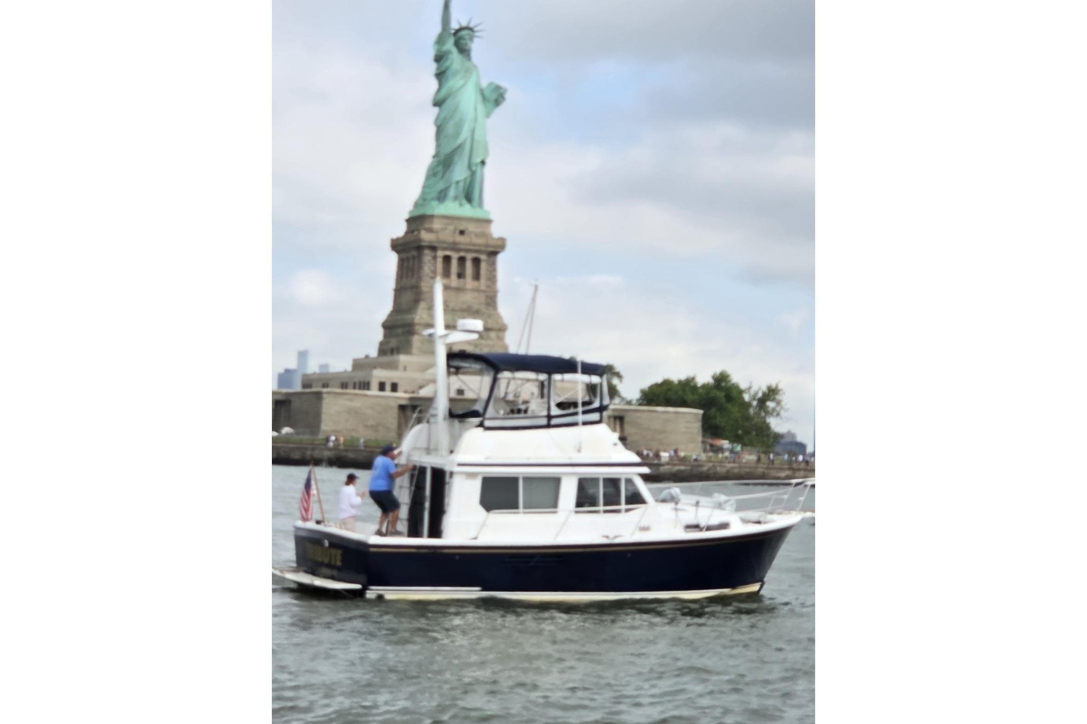 Sabre 34 boat near Statue of Liberty, 1999 model, cruising in New York Harbor.