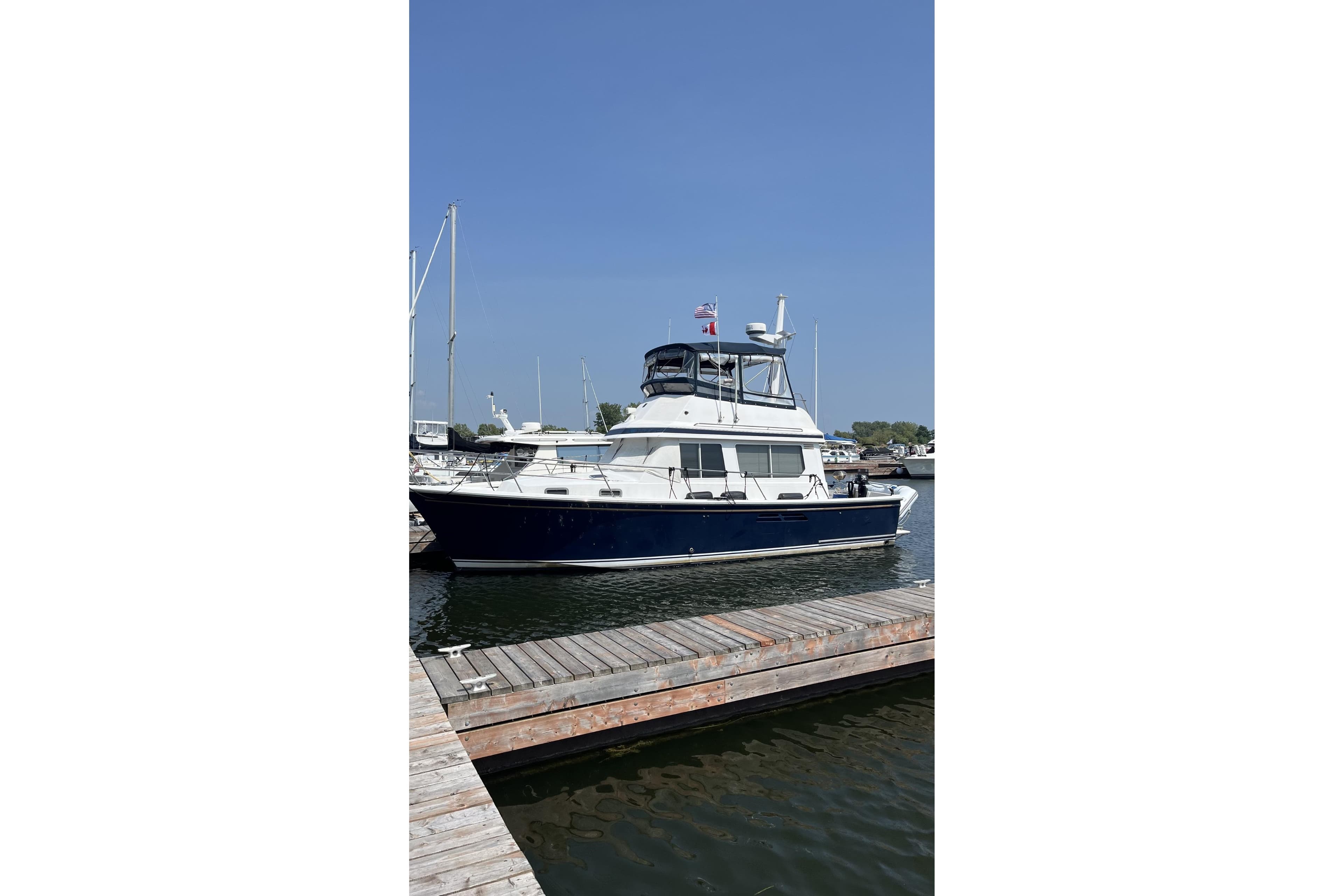 1999 Sabre 34 yacht docked at marina under clear blue sky.