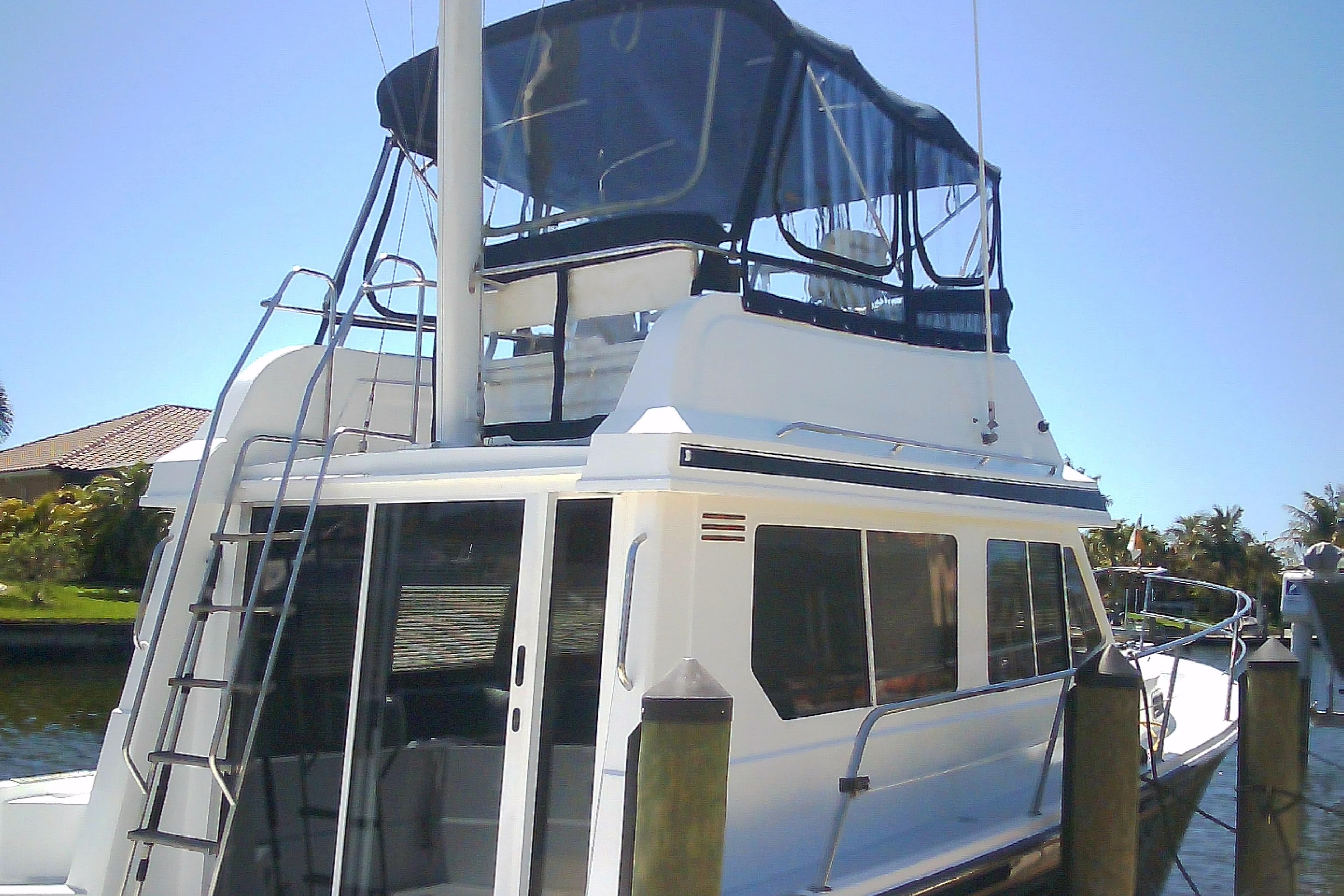 1999 Sabre 34 yacht docked, featuring a flybridge and sleek design.
