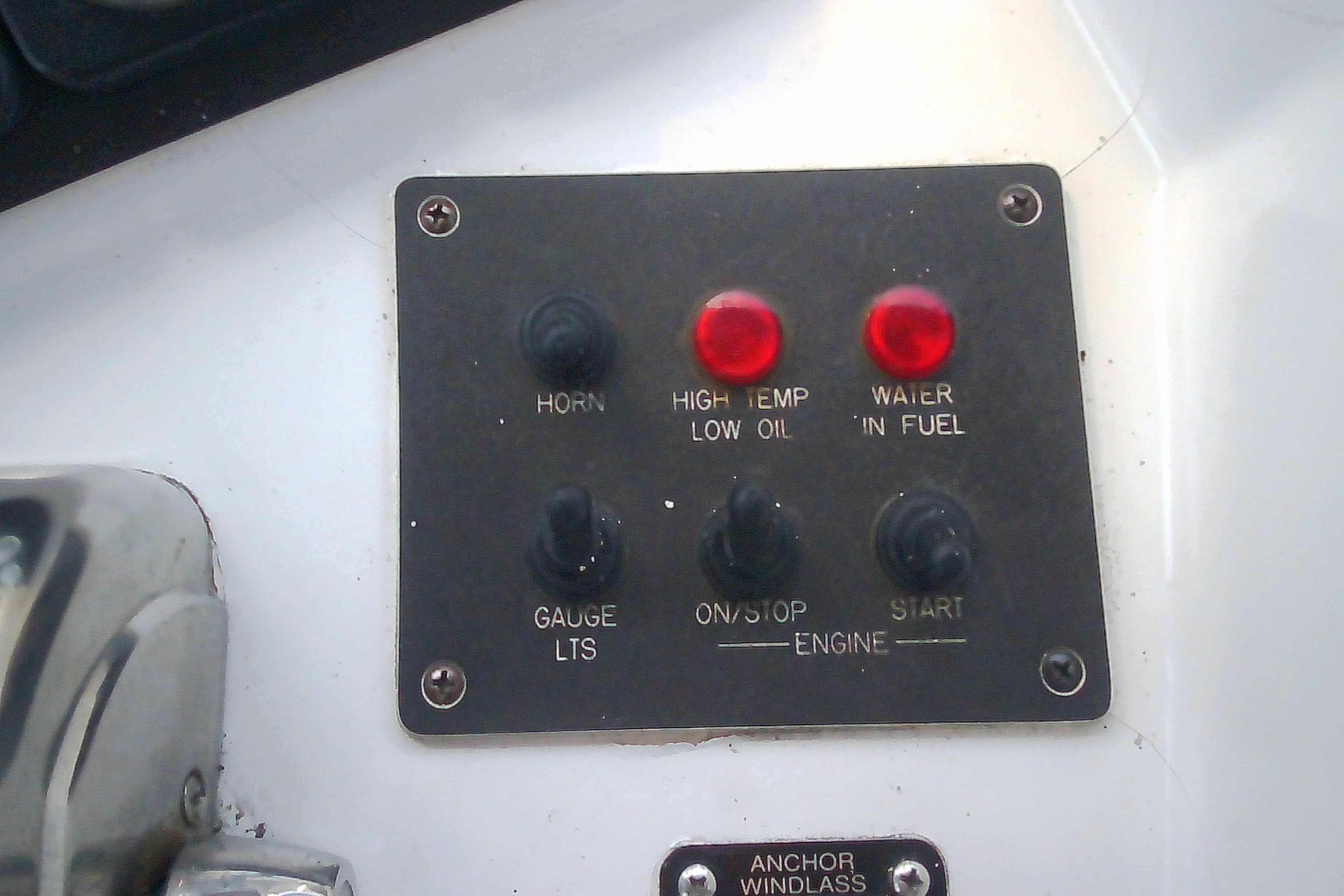 Control panel of a 1999 Sabre 34 boat with indicator lights and switches.