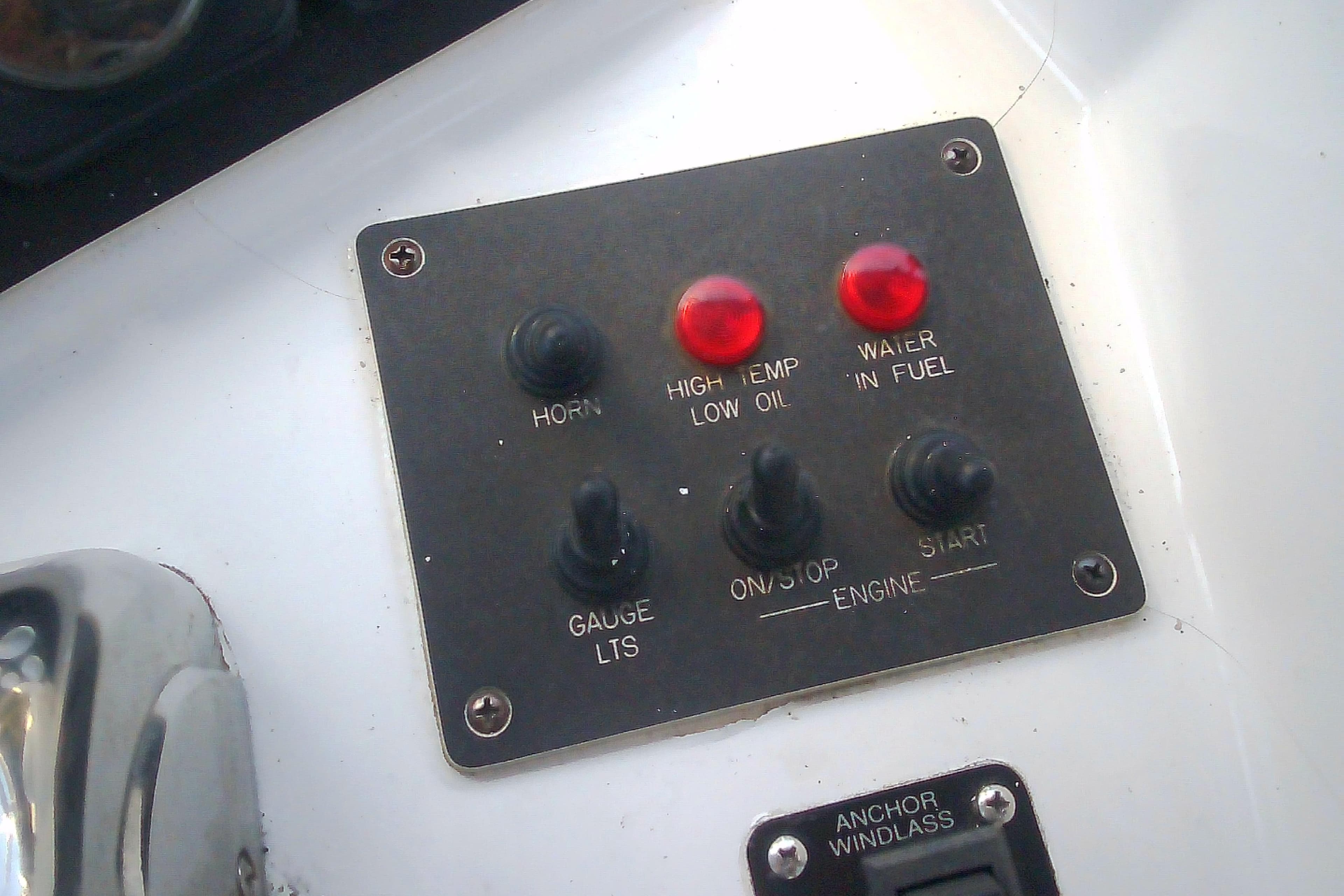Control panel of a 1999 Sabre 34 boat with switches and warning lights.