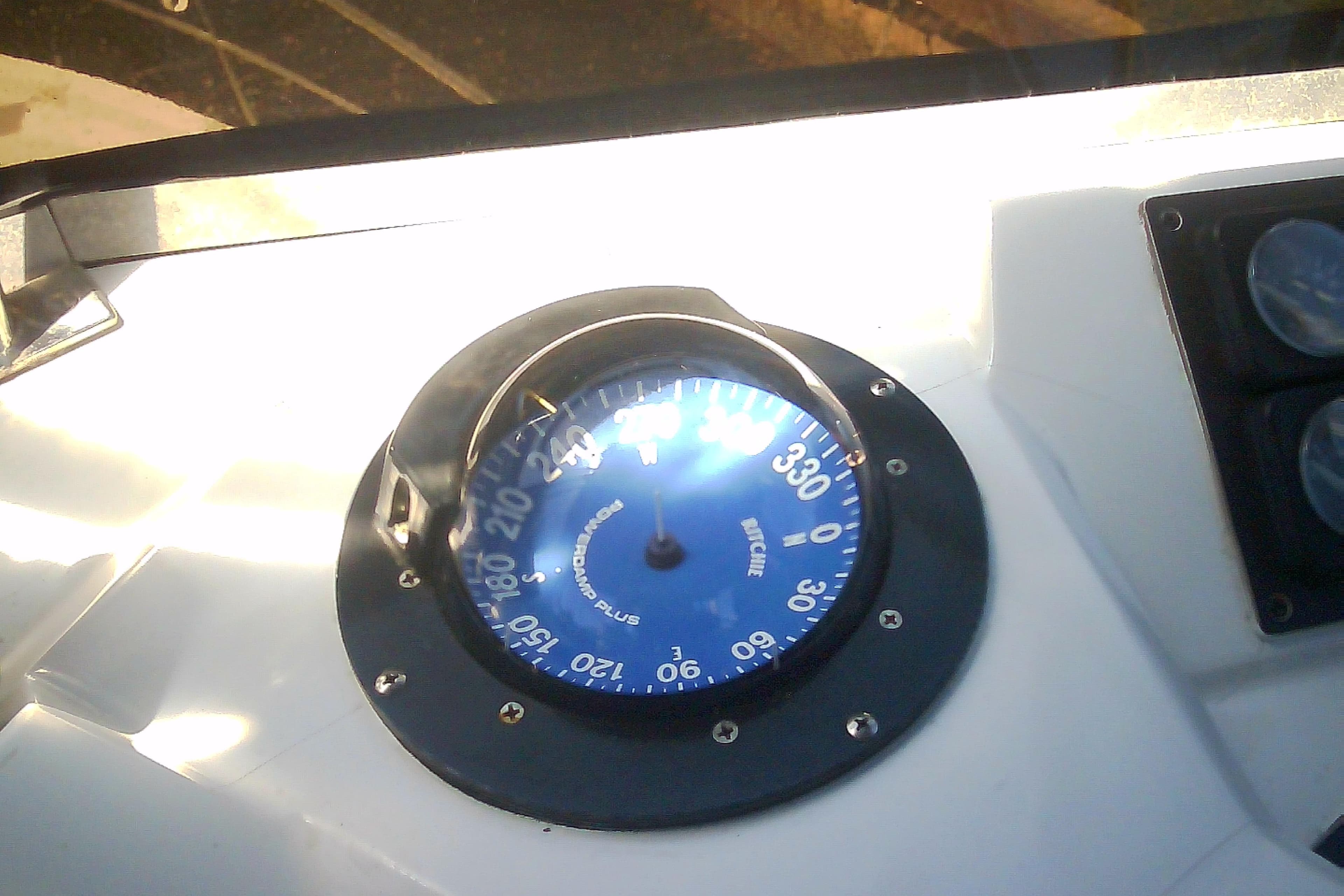 Boat compass on a 1999 Sabre 34, displaying navigational directions.