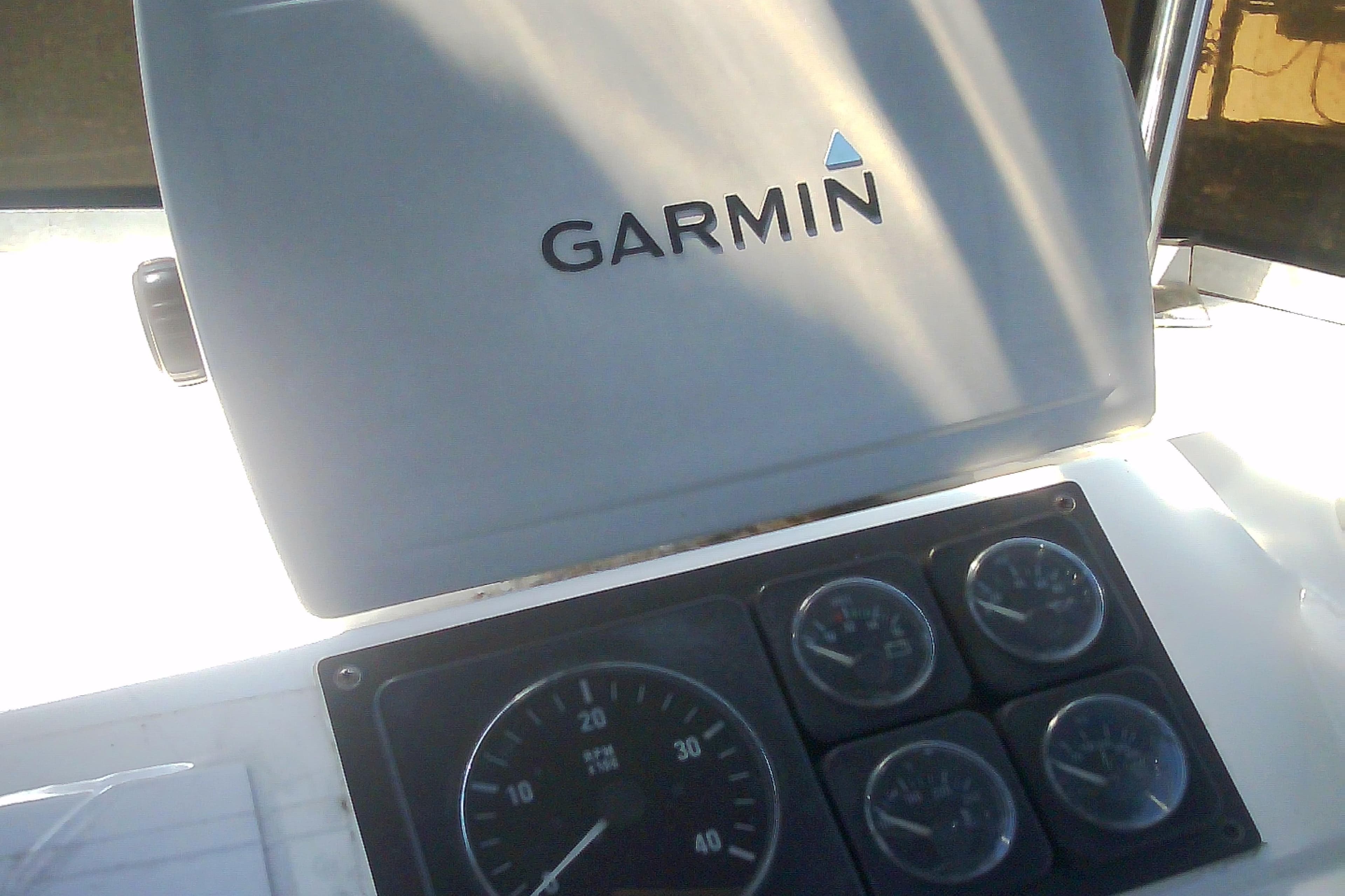 Garmin navigation system and gauges on 1999 Sabre 34 boat dashboard.