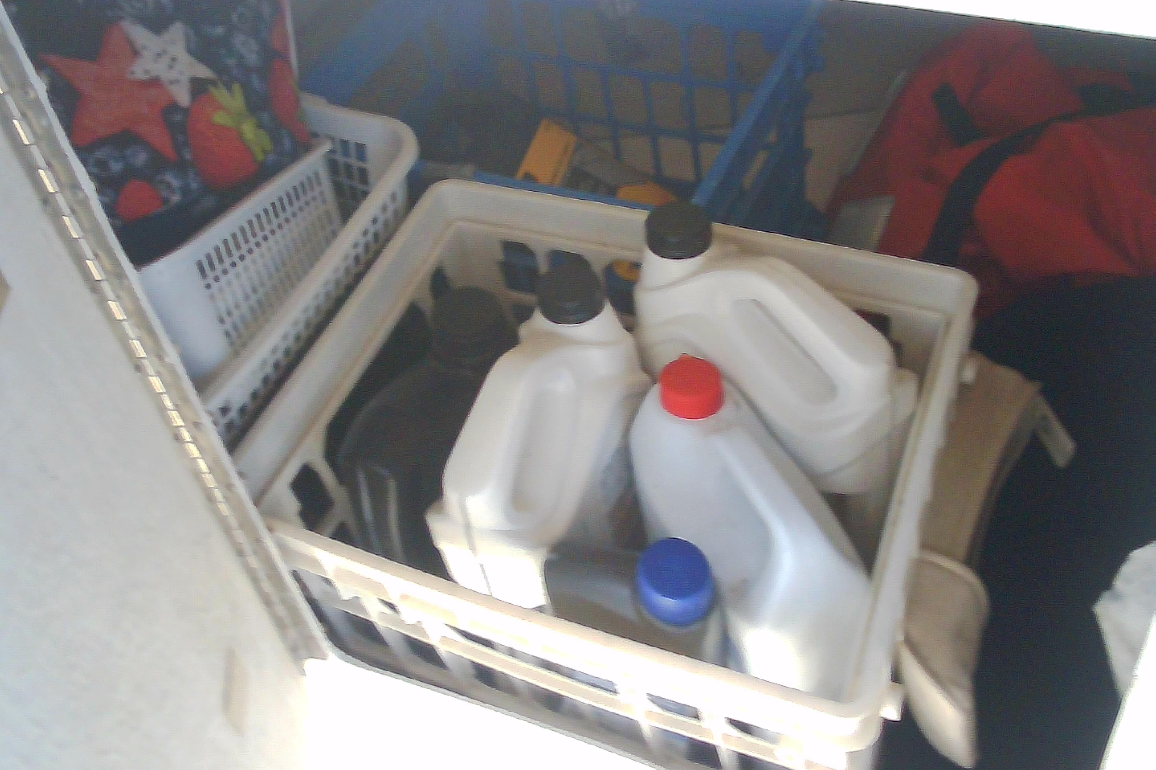 Storage compartment with plastic containers and assorted items on a Sabre 34, 1999 model.