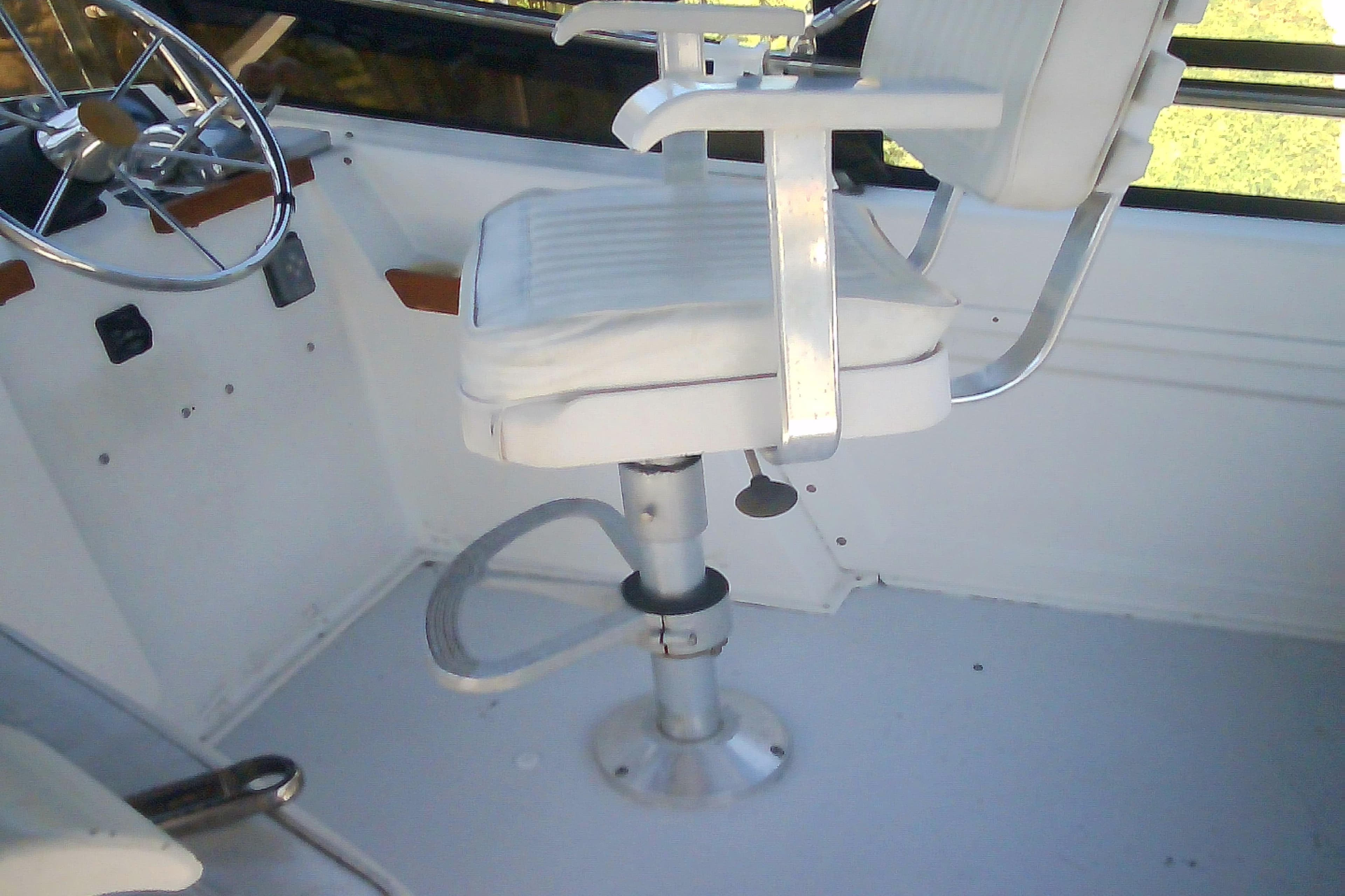 Captain's chair and steering wheel on a 1999 Sabre 34 boat.
