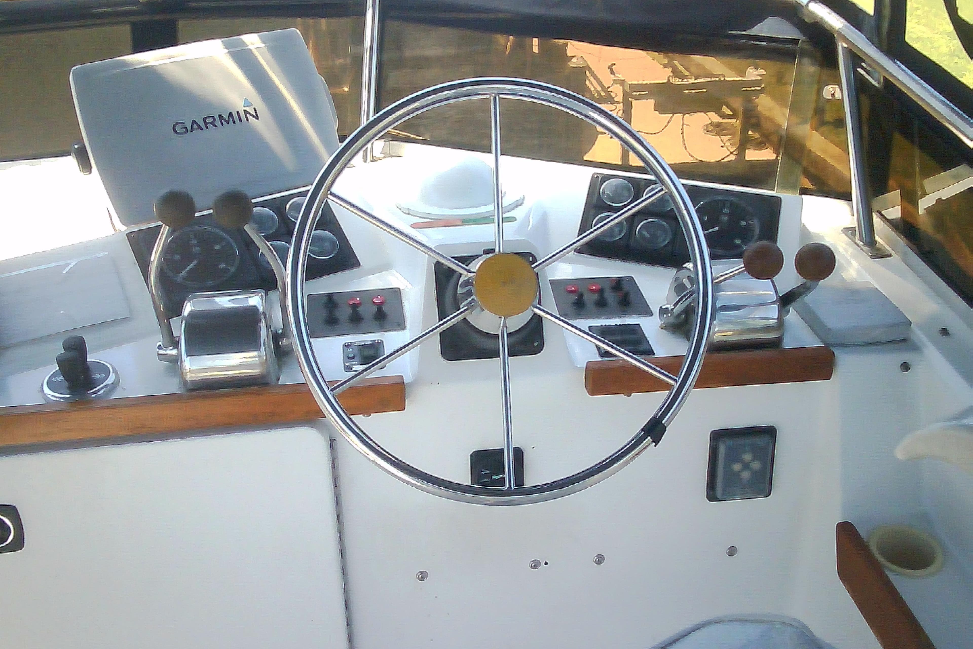 Helm of 1999 Sabre 34 sailboat with Garmin navigation system and steering wheel.