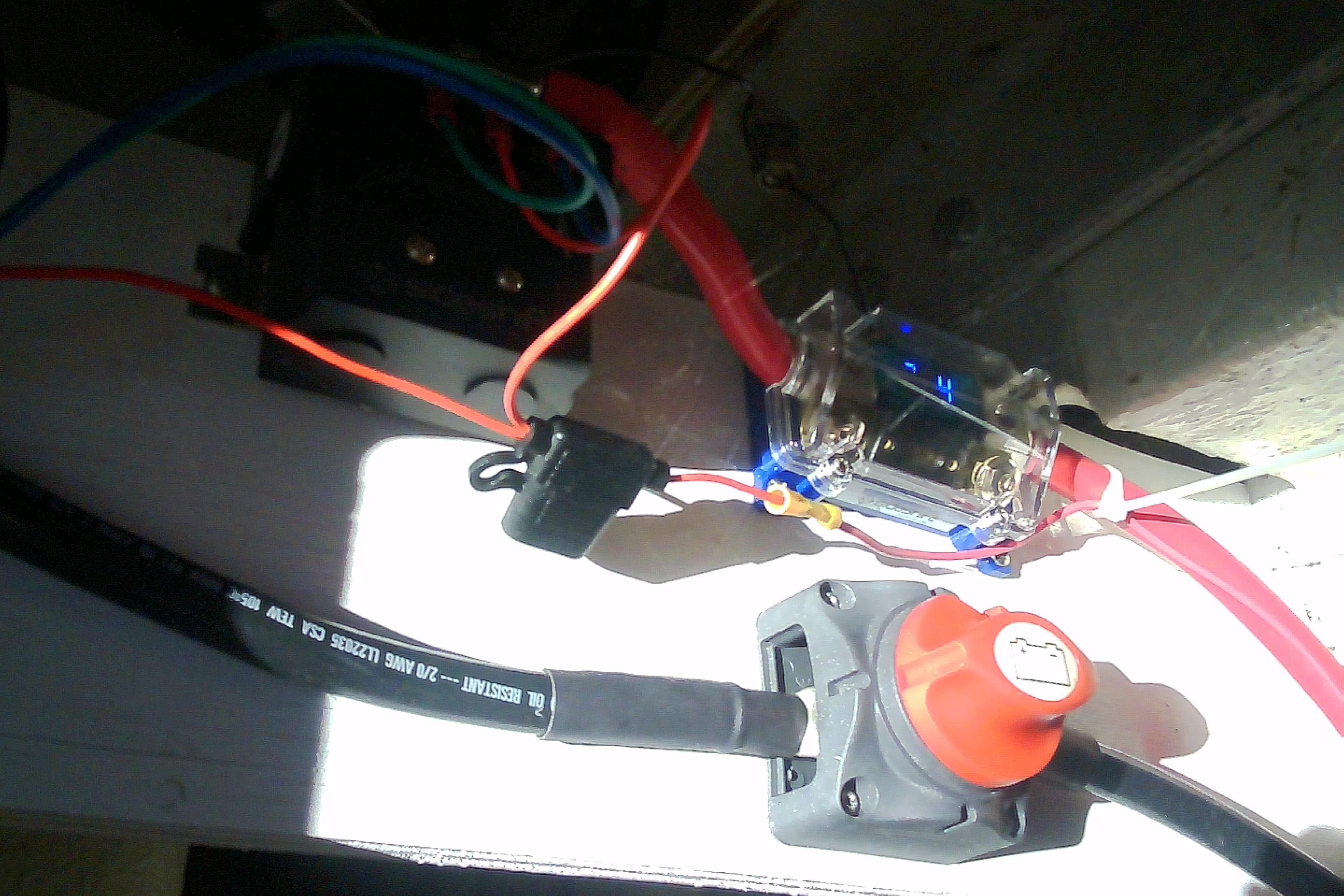 Electrical wiring setup in a 1999 Sabre 34 boat, featuring cables and connectors.