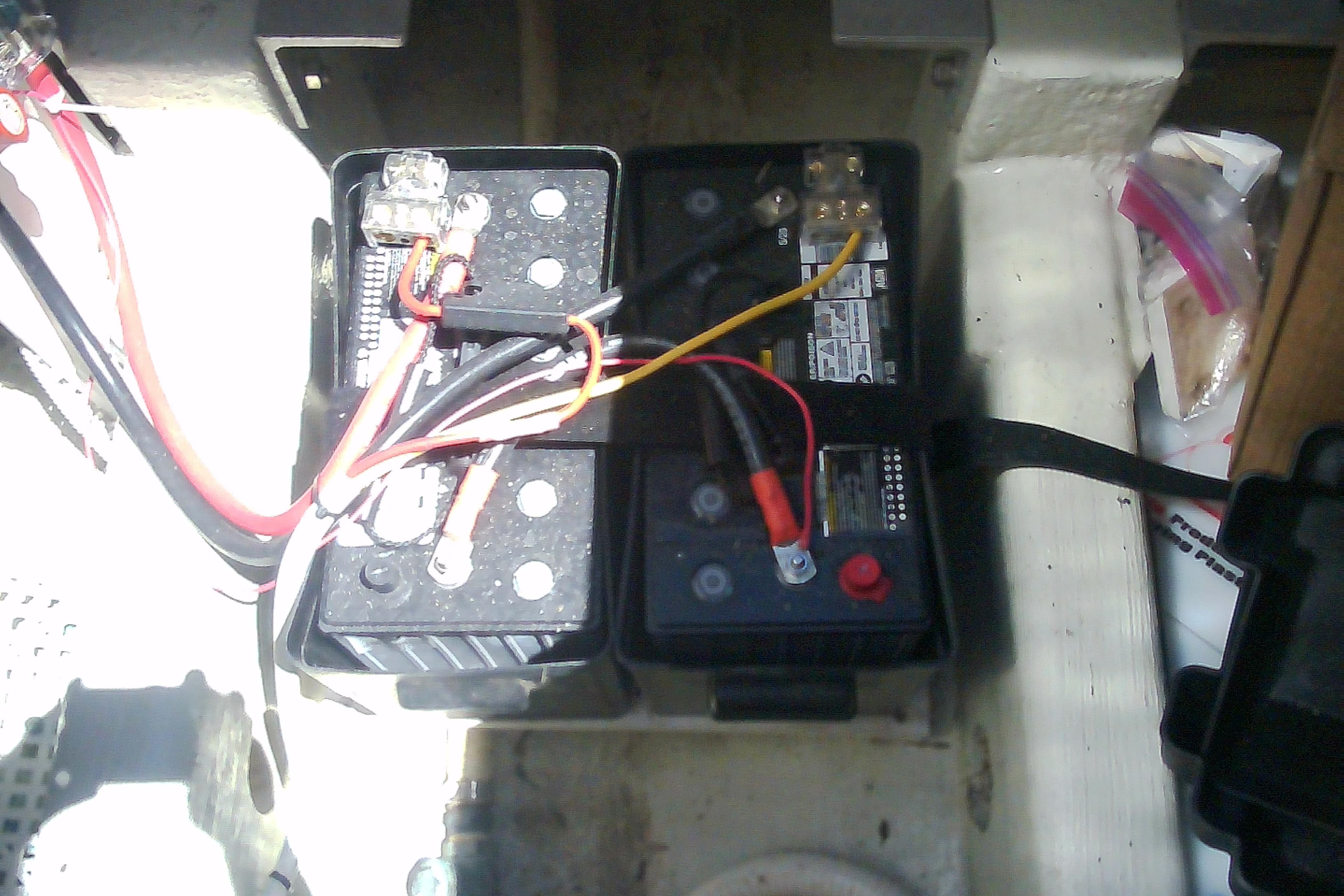 Battery compartment of a 1999 Sabre 34 with connected wiring and components.