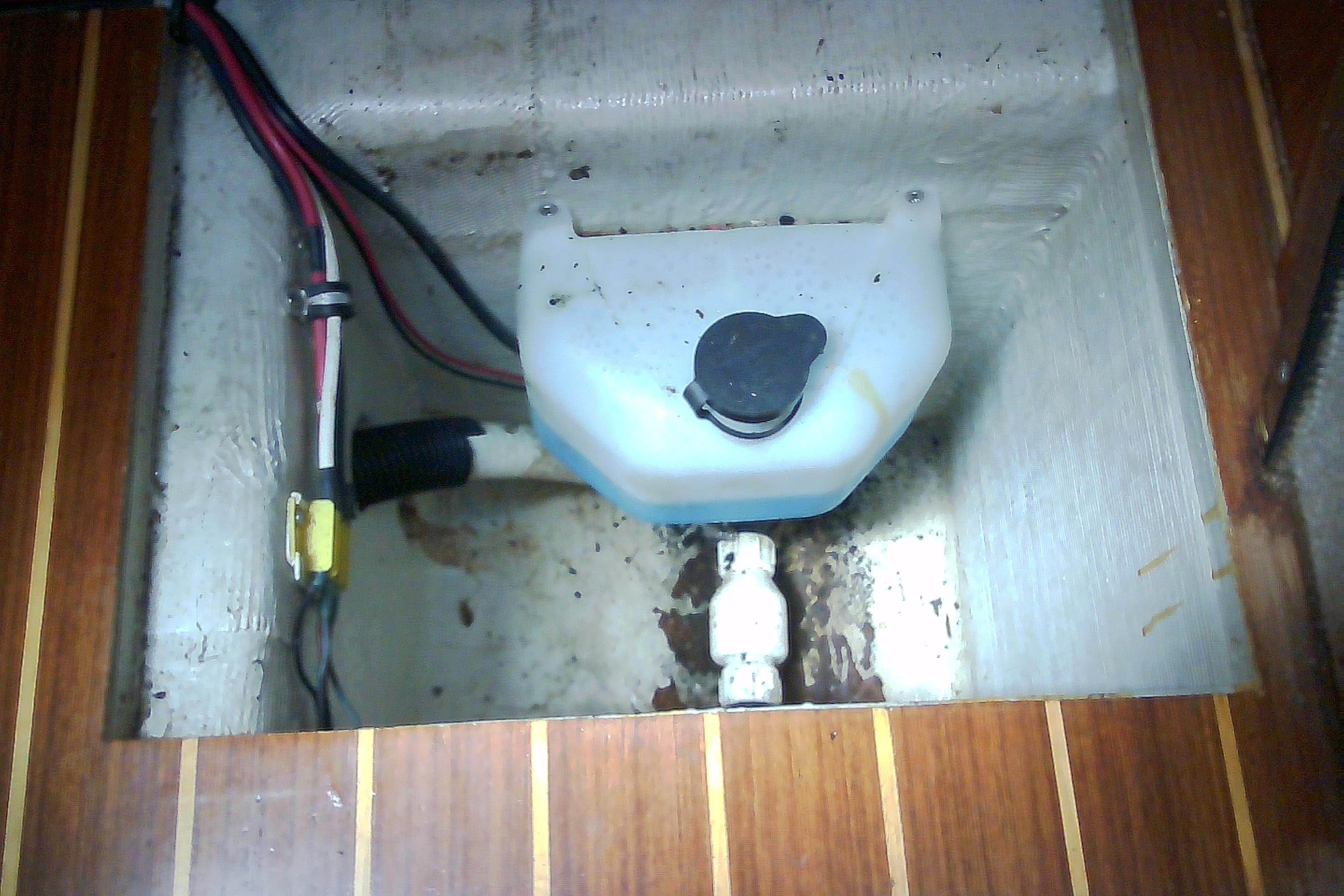 Boat engine compartment with wiring and fluid reservoir, Sabre 34, 1999 model.