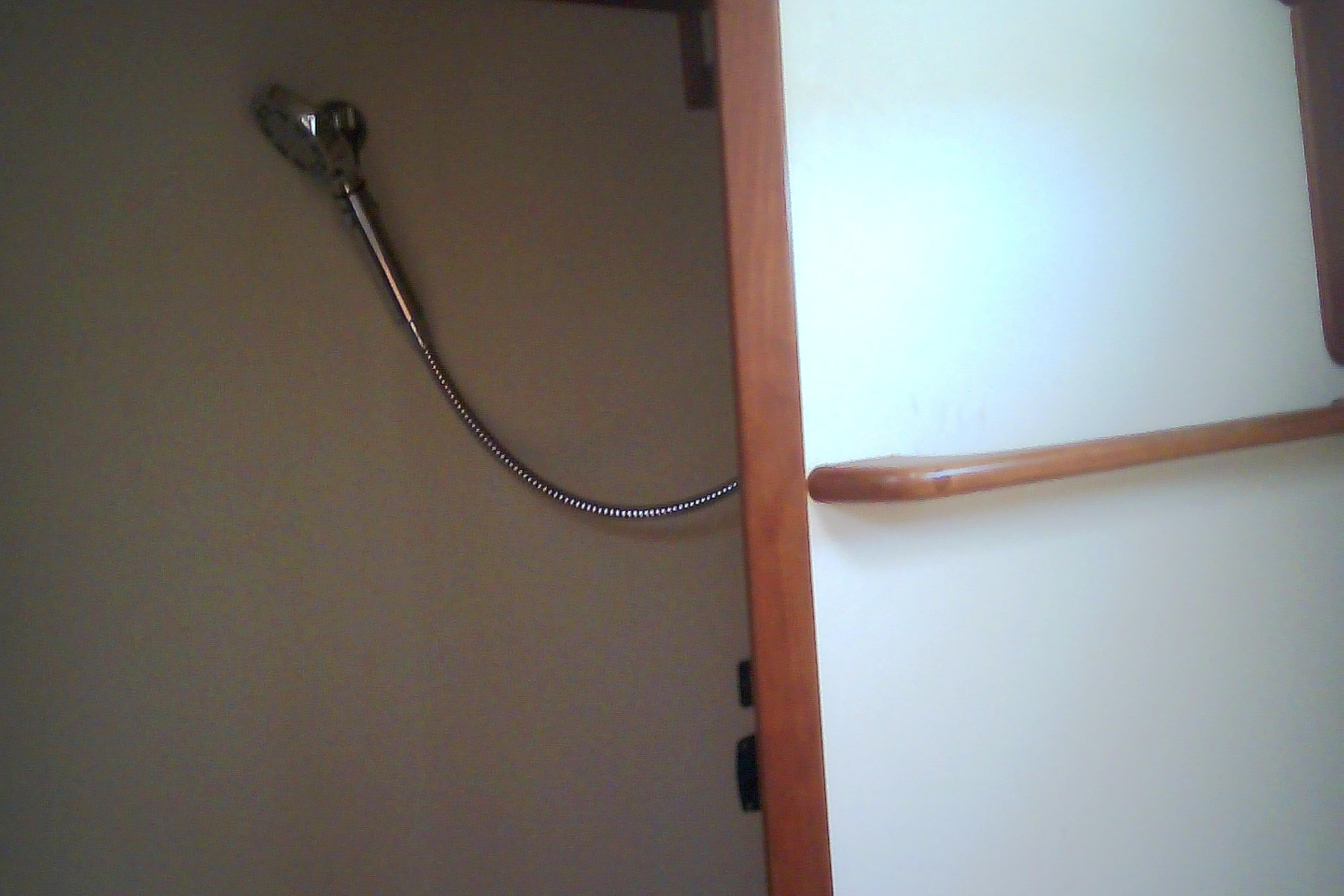 Interior of 1999 Sabre 34 yacht showing shower area with wooden trim.