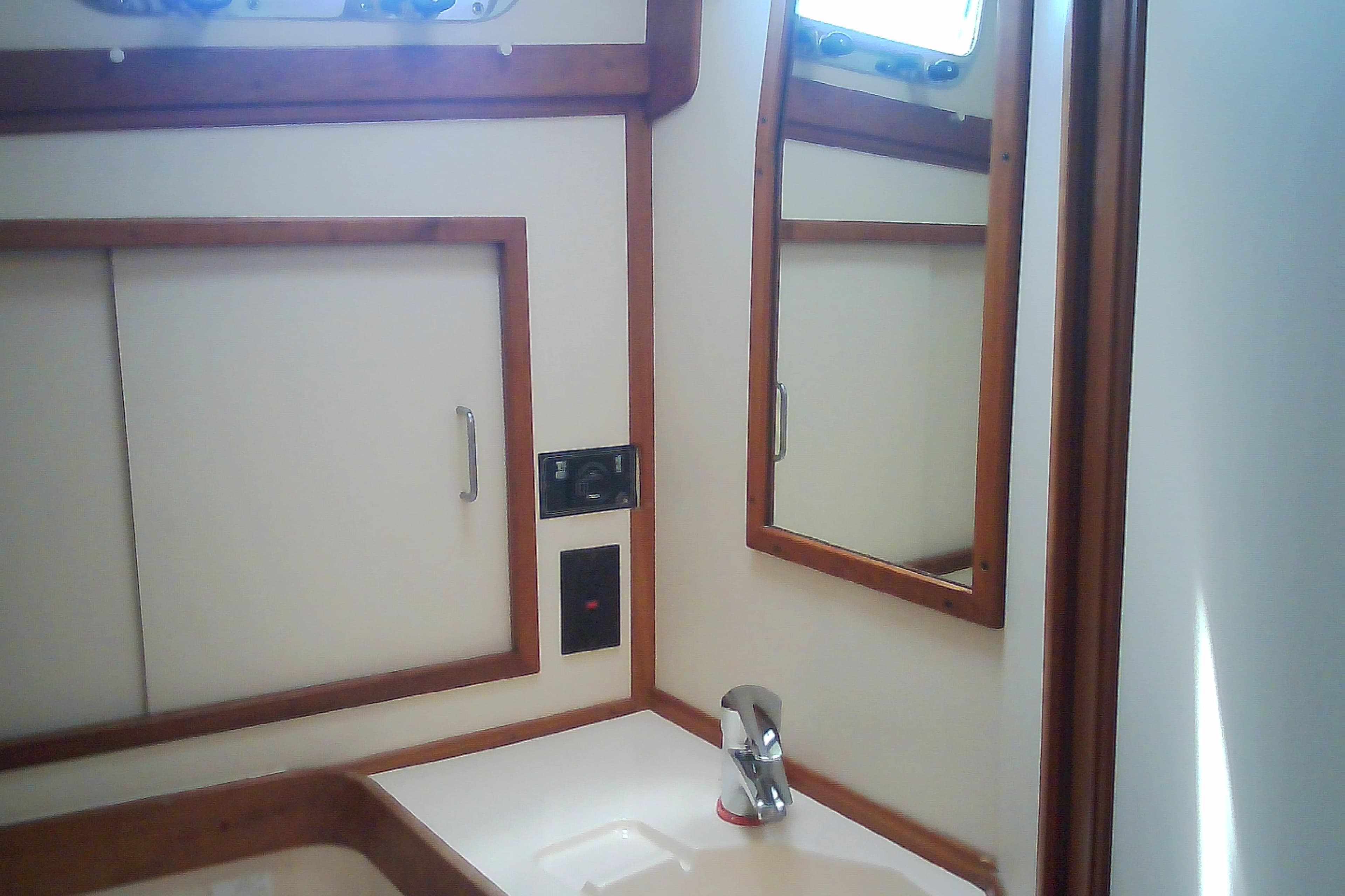 Interior of 1999 Sabre 34 yacht bathroom with mirror and sink.