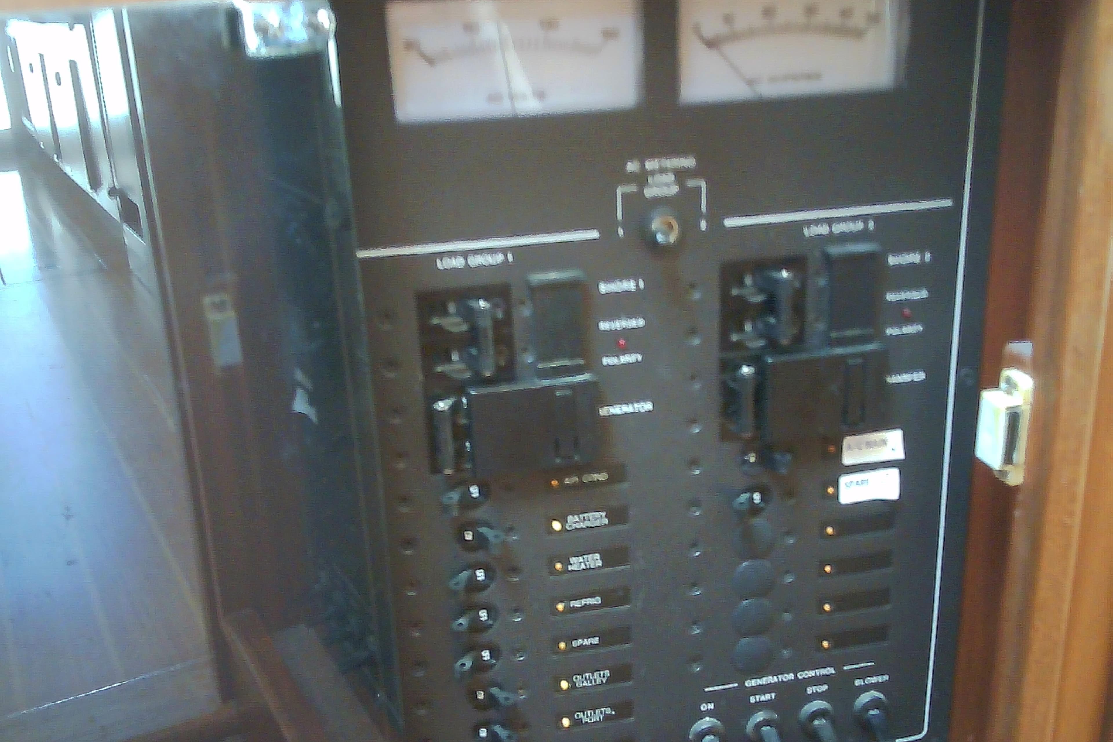 Electrical control panel on a 1999 Sabre 34 boat, featuring switches and gauges.