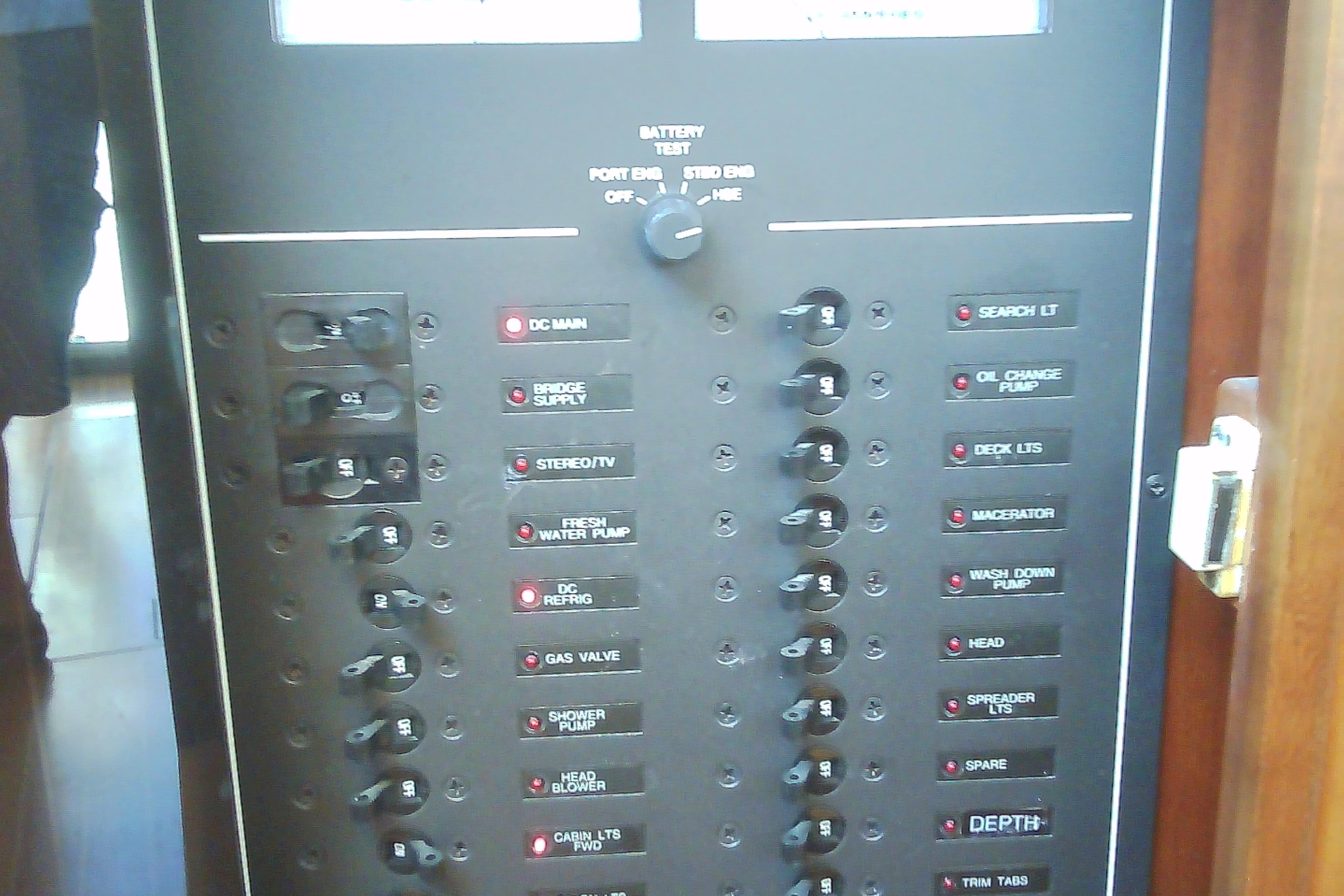Electrical control panel on a 1999 Sabre 34 boat, featuring various switches and labels.