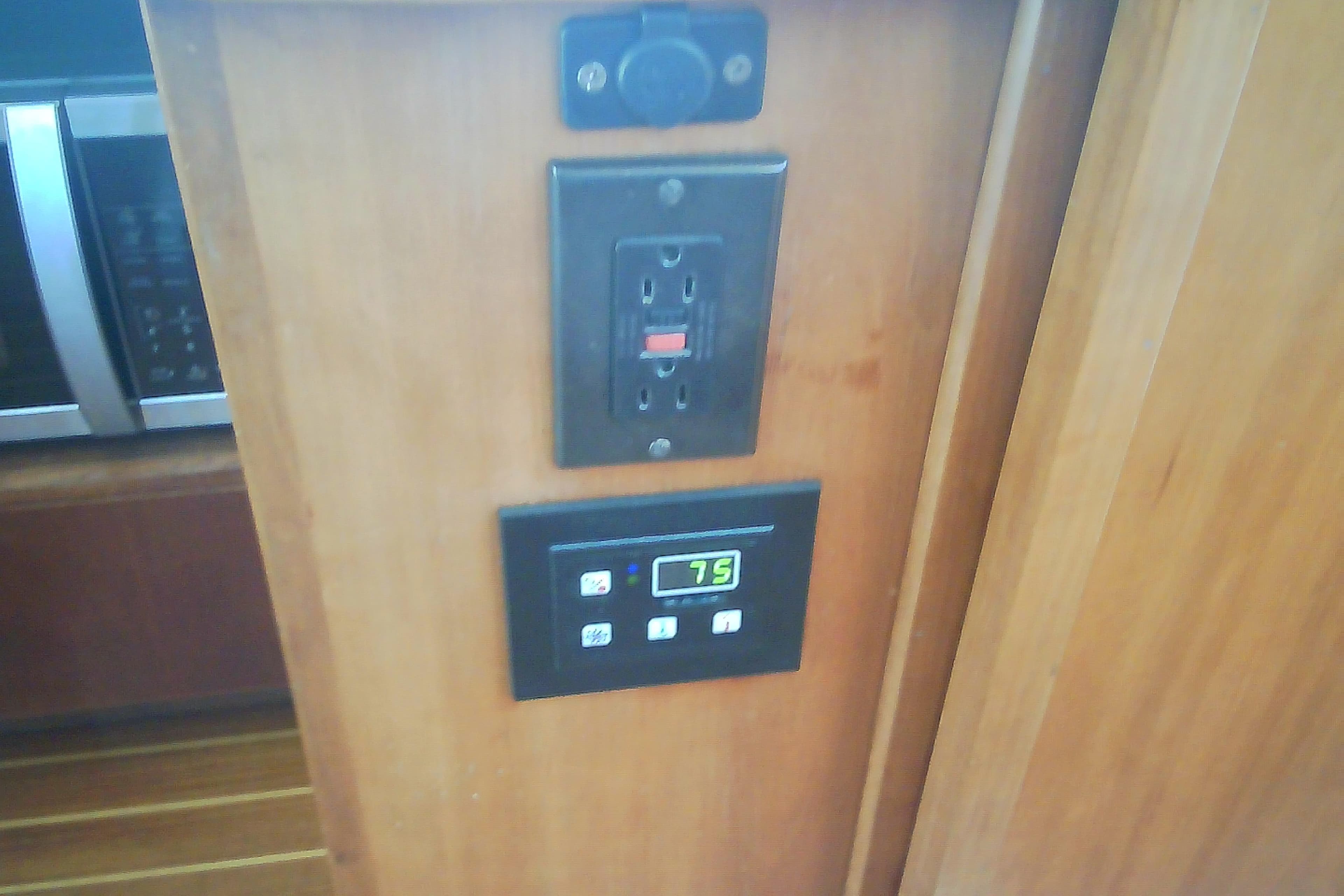Electrical outlet and control panel on a 1999 Sabre 34 boat interior.