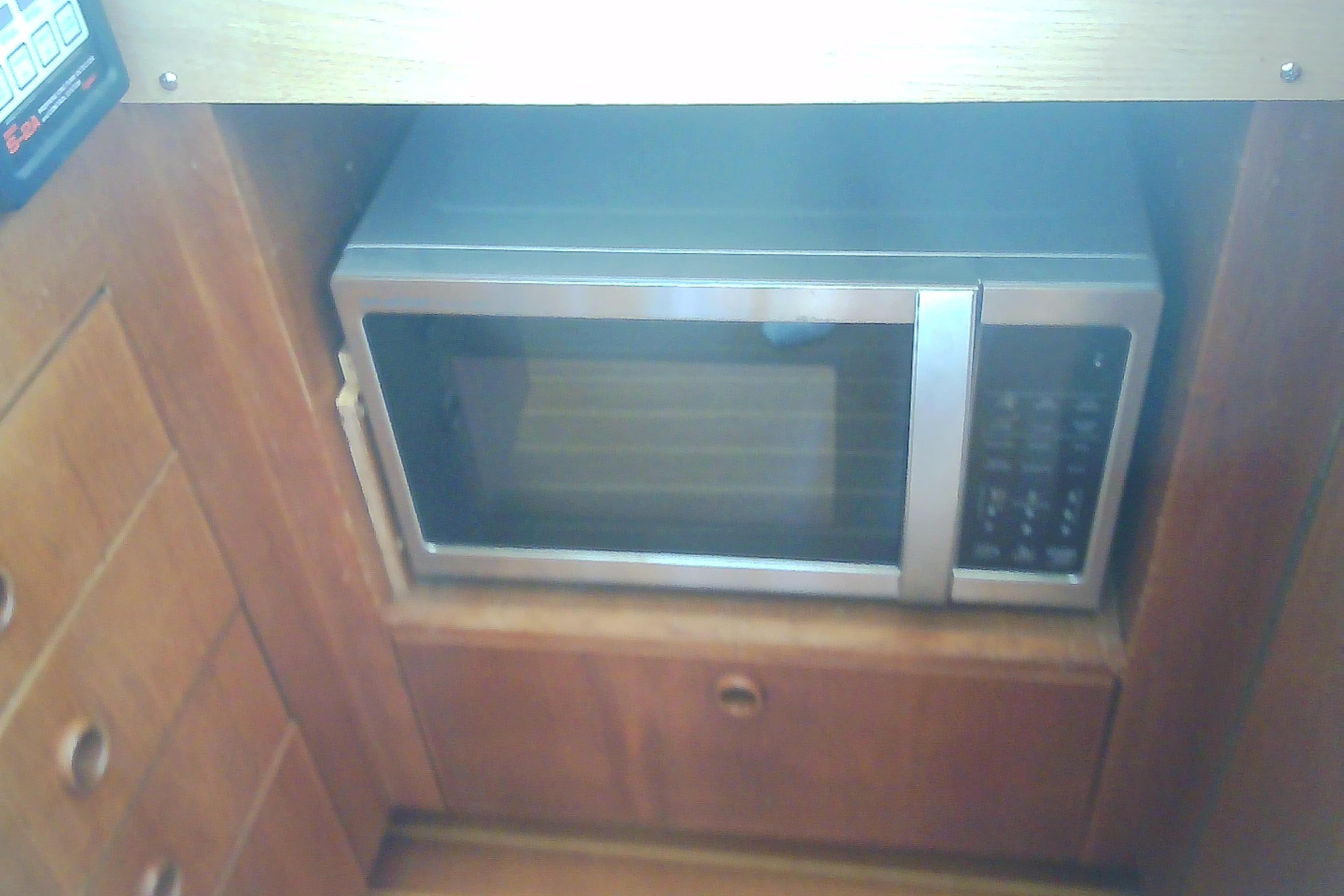 Built-in microwave in a 1999 Sabre 34 boat kitchen cabinet.