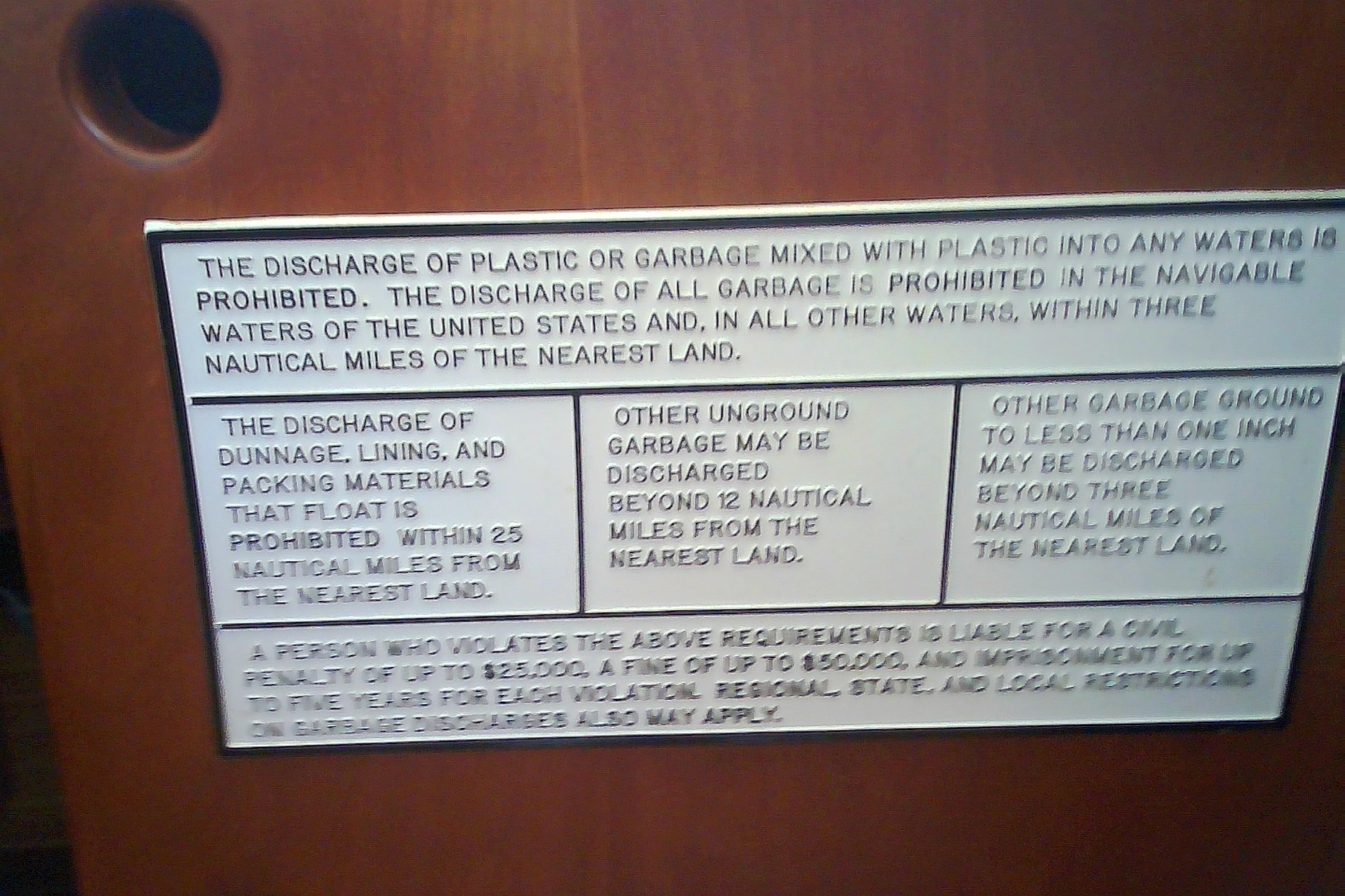 Sign detailing garbage discharge regulations on a 1999 Sabre 34 boat.